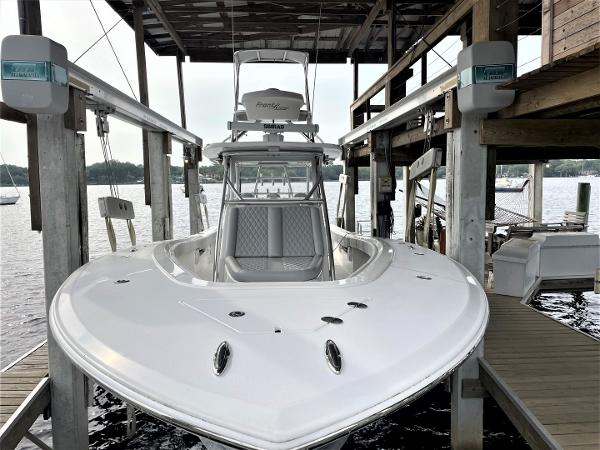 2020 Front Runner 39 Center Console boat docked under a wooden shelter.