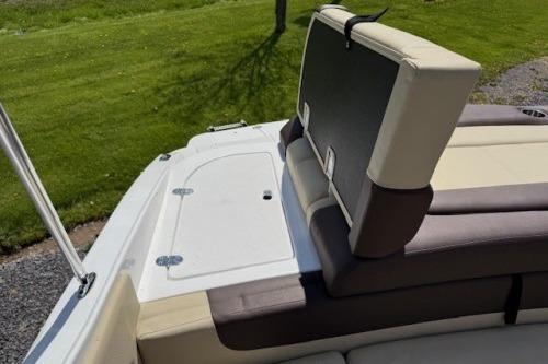 2017 Rinker QX21 BR boat with beige and brown seating on a sunny day.
