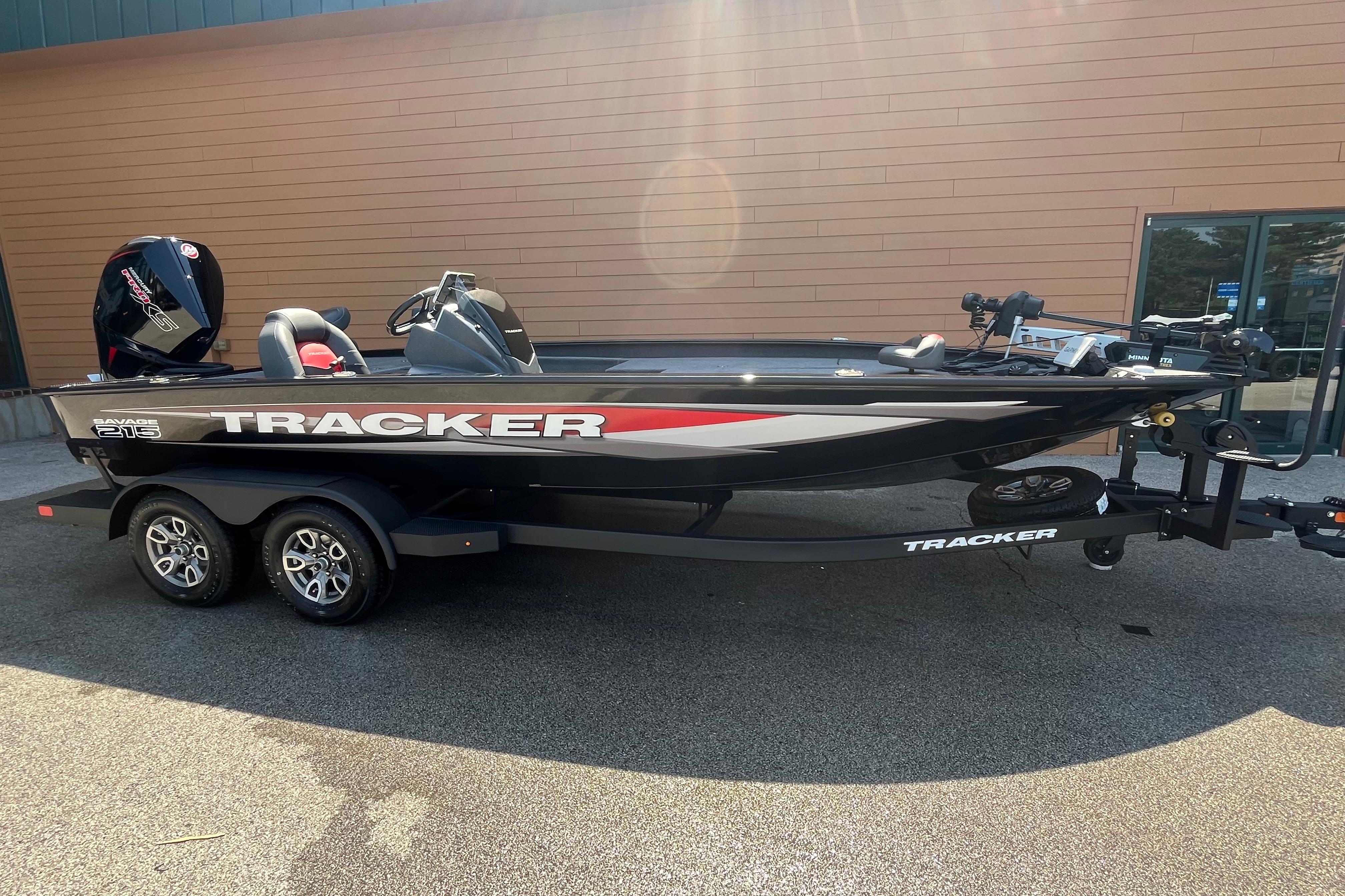 2026 Tracker Savage 215 boat on trailer, parked outdoors, side view.