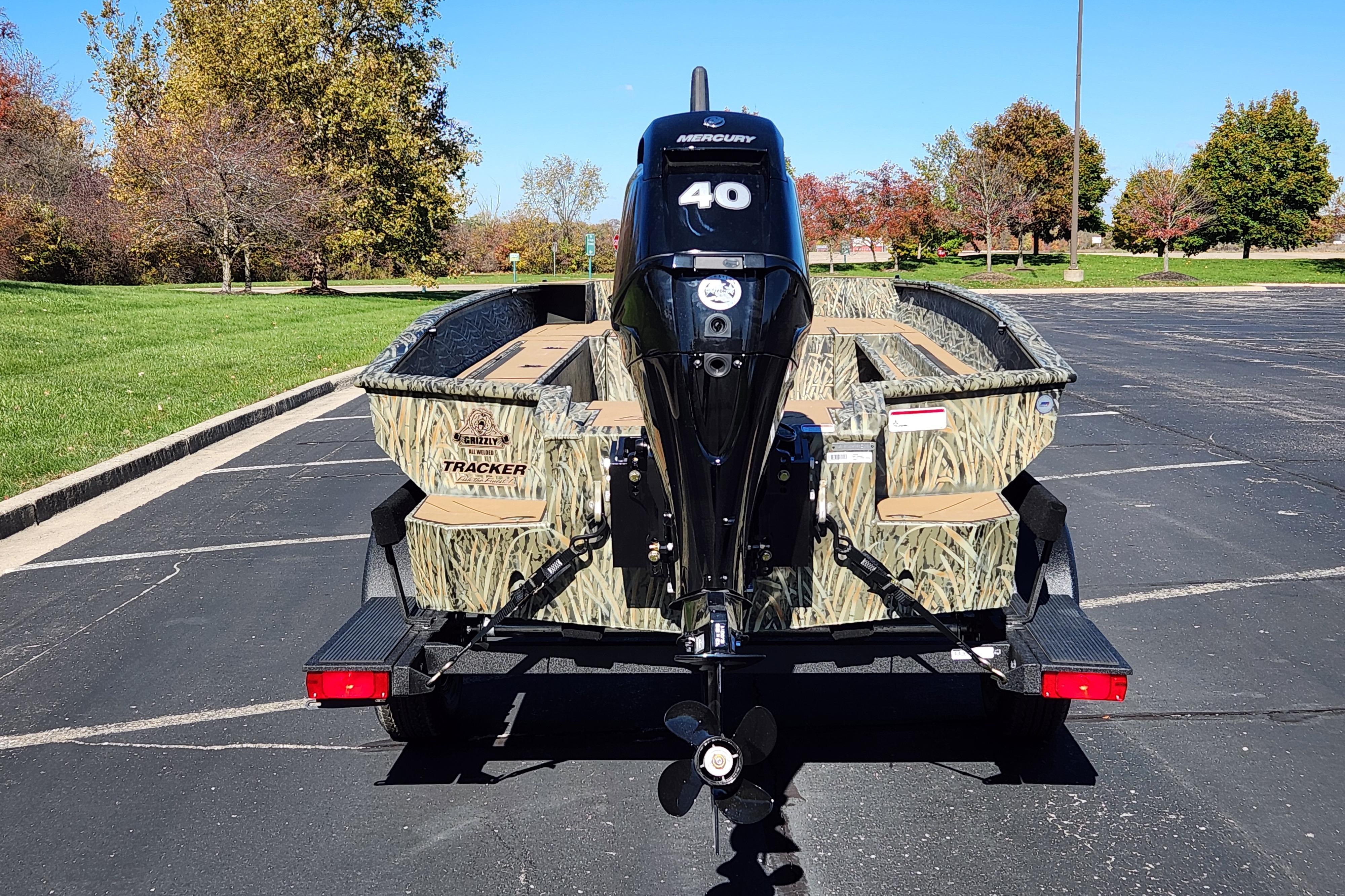 2026 Tracker Grizzly 1756 T Marsh boat with Mercury 40 engine in parking lot.