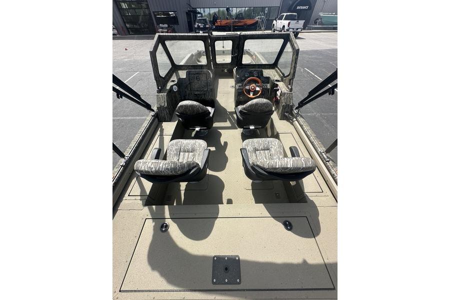 2026 SeaArk EasyCat boat interior with four seats and steering wheel, parked outdoors.