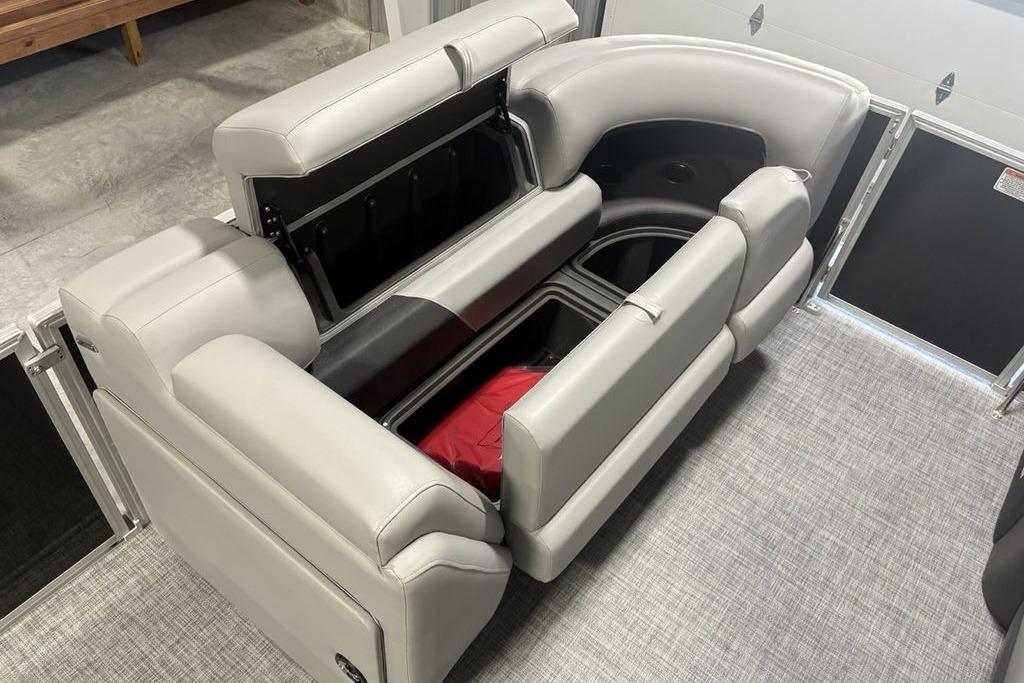 2026 Sun Tracker PARTY BARGE® 20 DLX interior seating with storage compartments open.