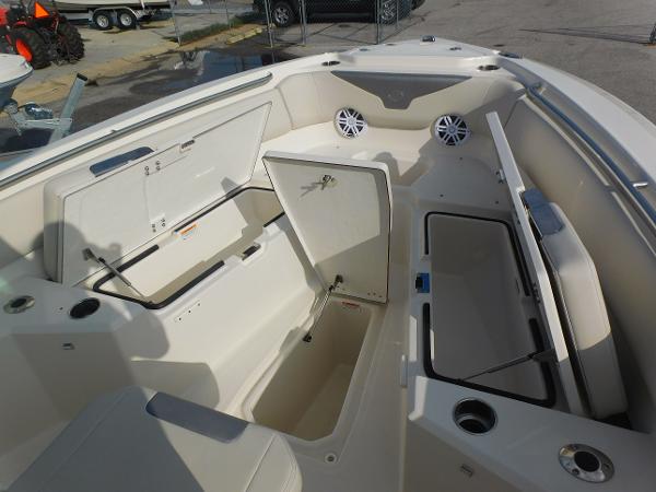 2025 Sailfish 232 CC boat interior with open storage compartments and cup holders.