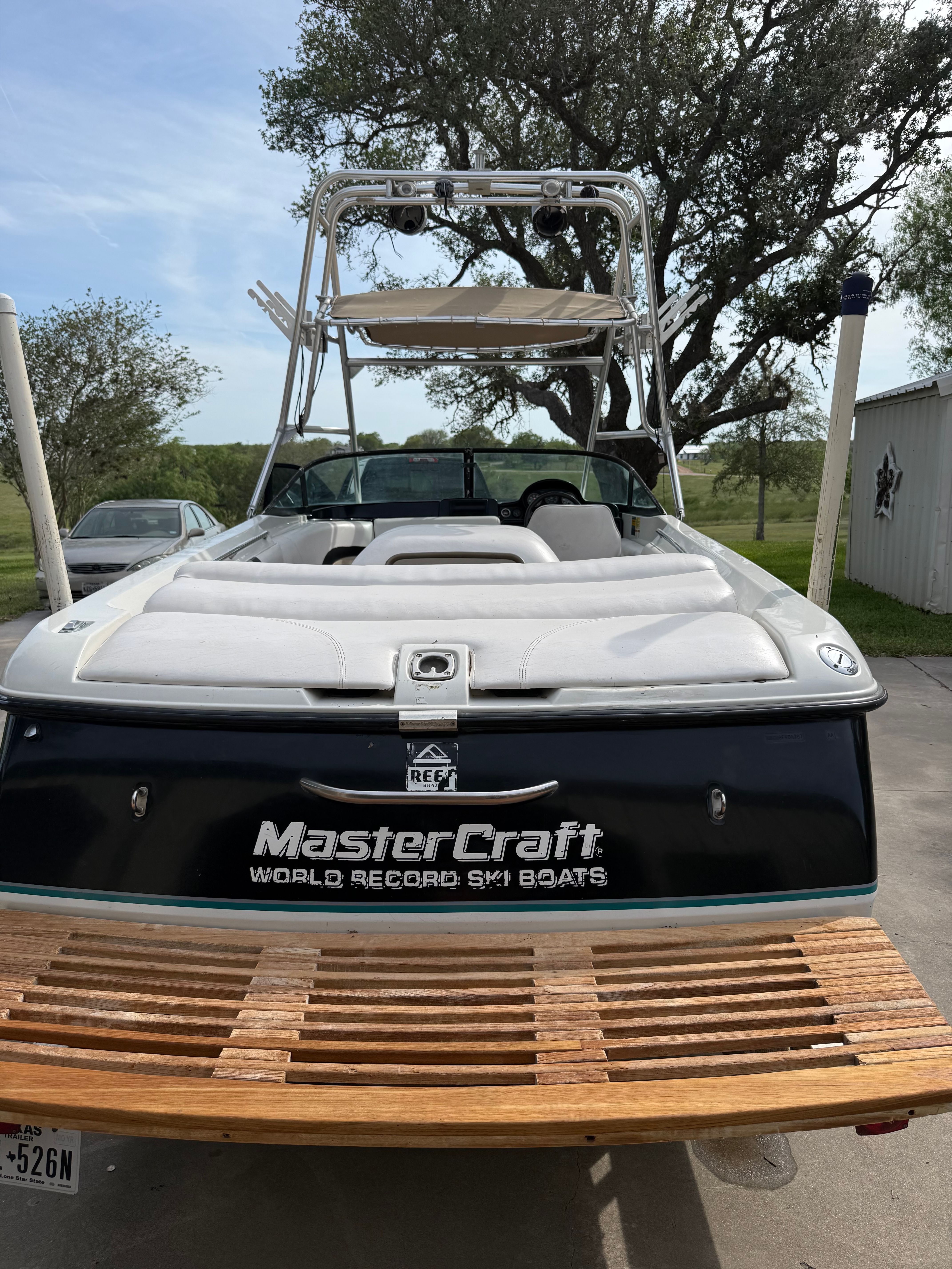 1997 MasterCraft ProStar 190 boat with wooden deck and white interior.