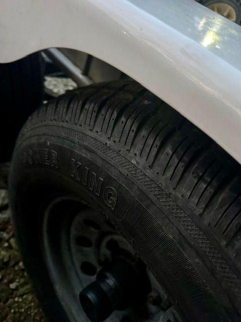 Close-up of a tire on a trailer carrying a boat.