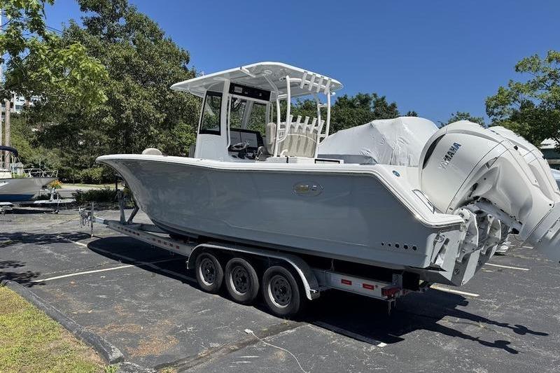 2026 Sea Hunt Gamefish 30 boat on trailer, featuring forward seating and dual Yamaha engines.