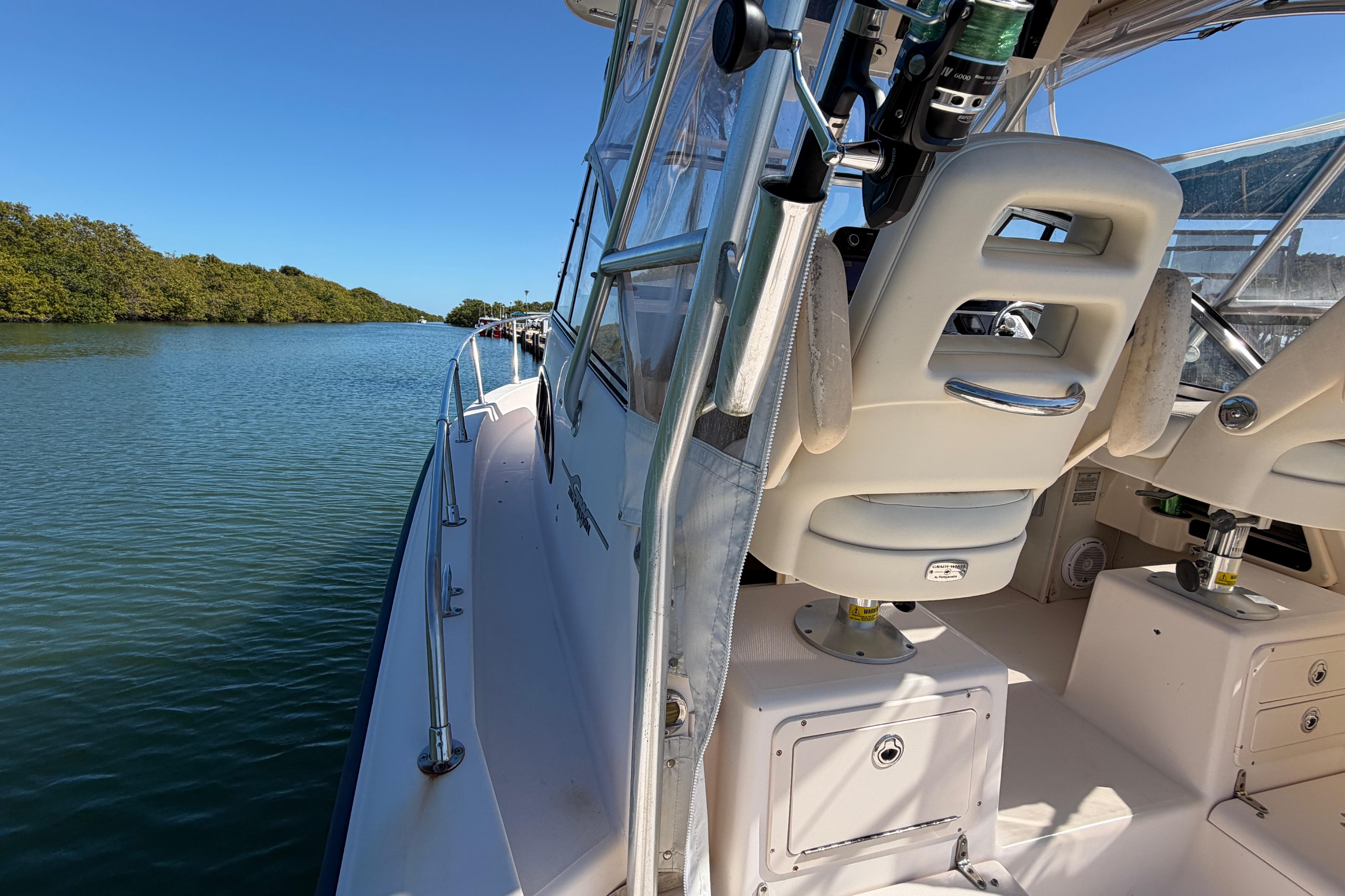 2006 Grady-White Sailfish 282 boat on calm water, featuring comfortable seating and clear skies.