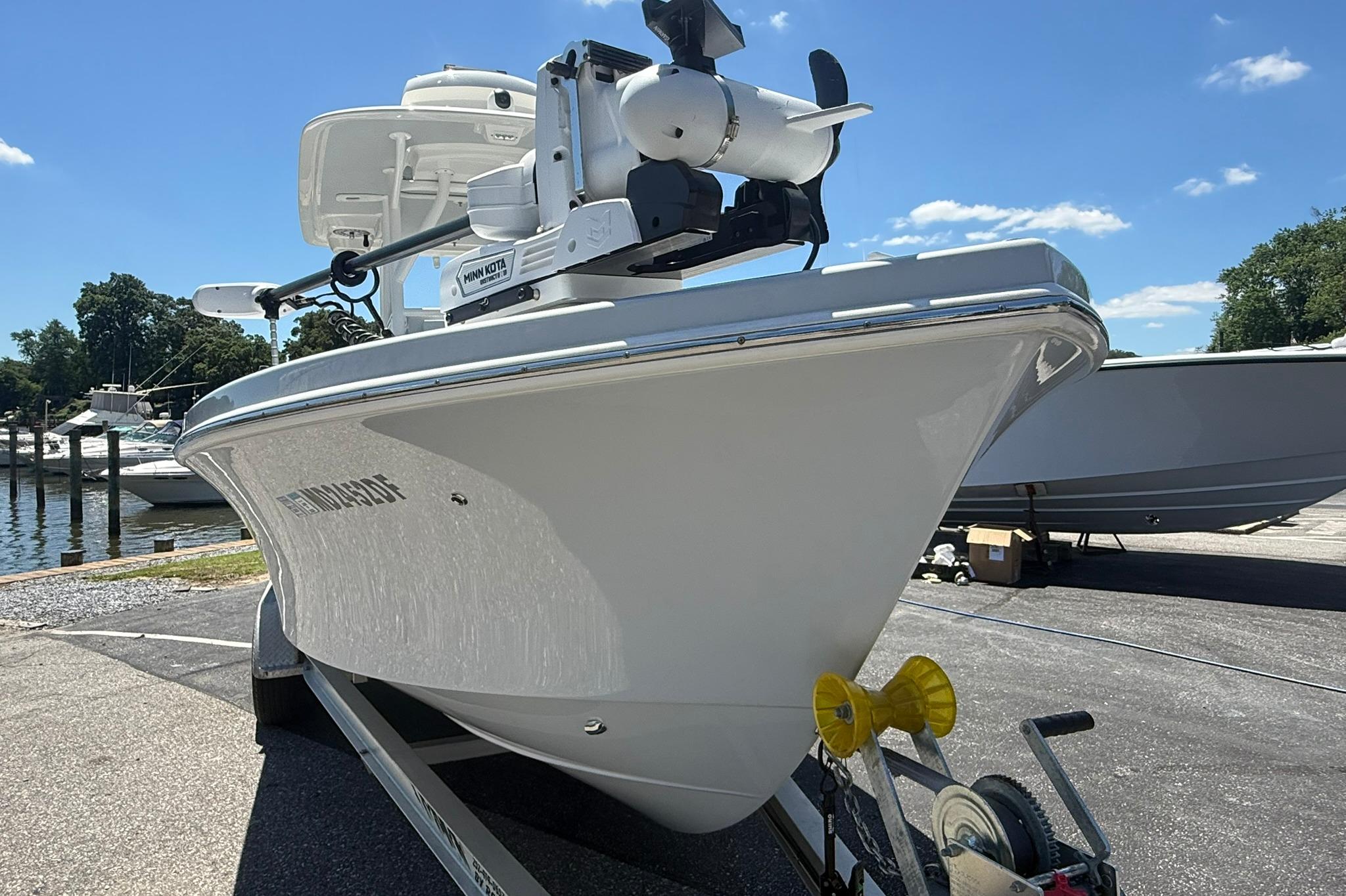 2024 Pair Customs 24 Center Console MV boat on trailer, dockside view.