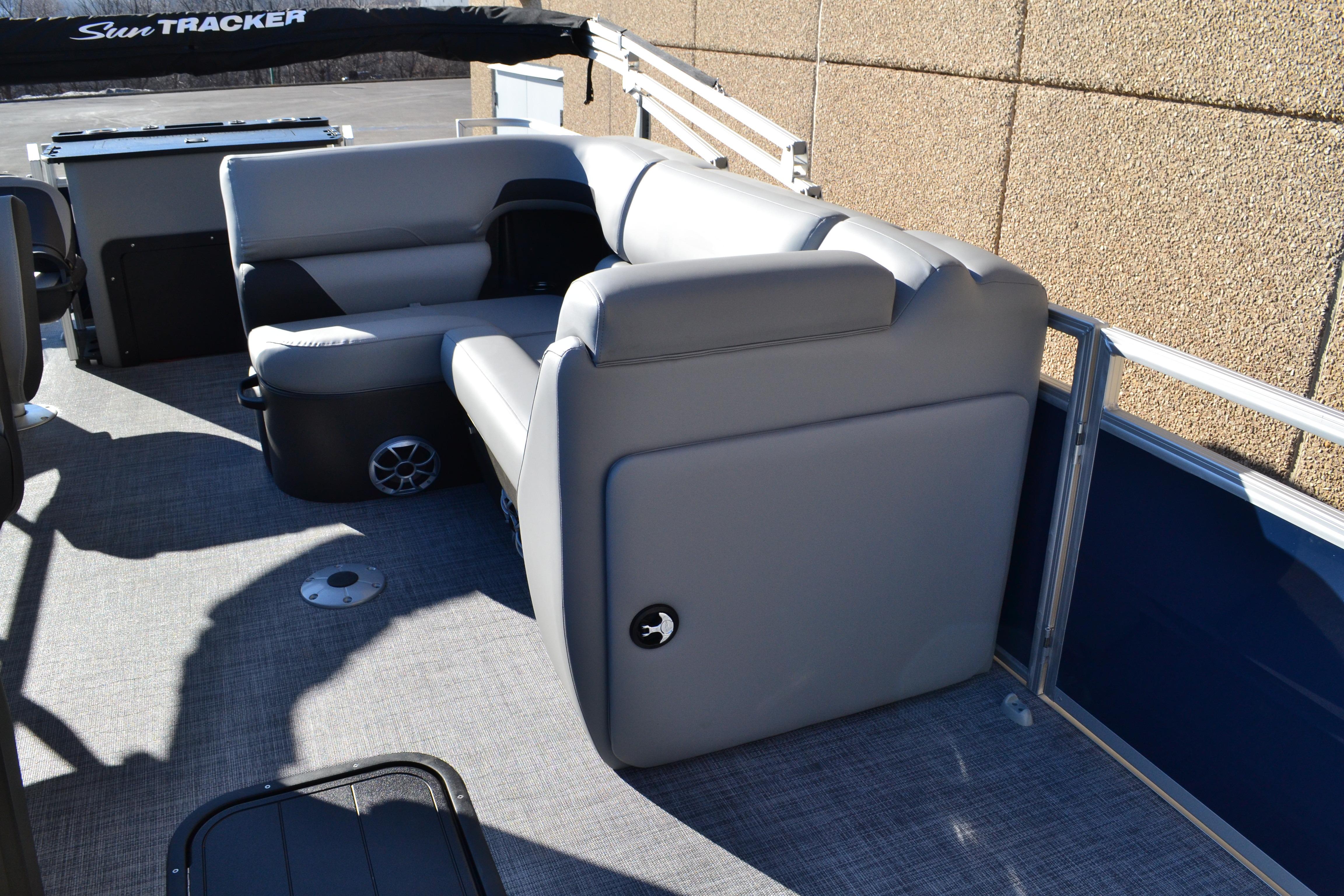 2026 Sun Tracker SportFish 22 XP3 pontoon boat interior with gray seating and carpeted floor.