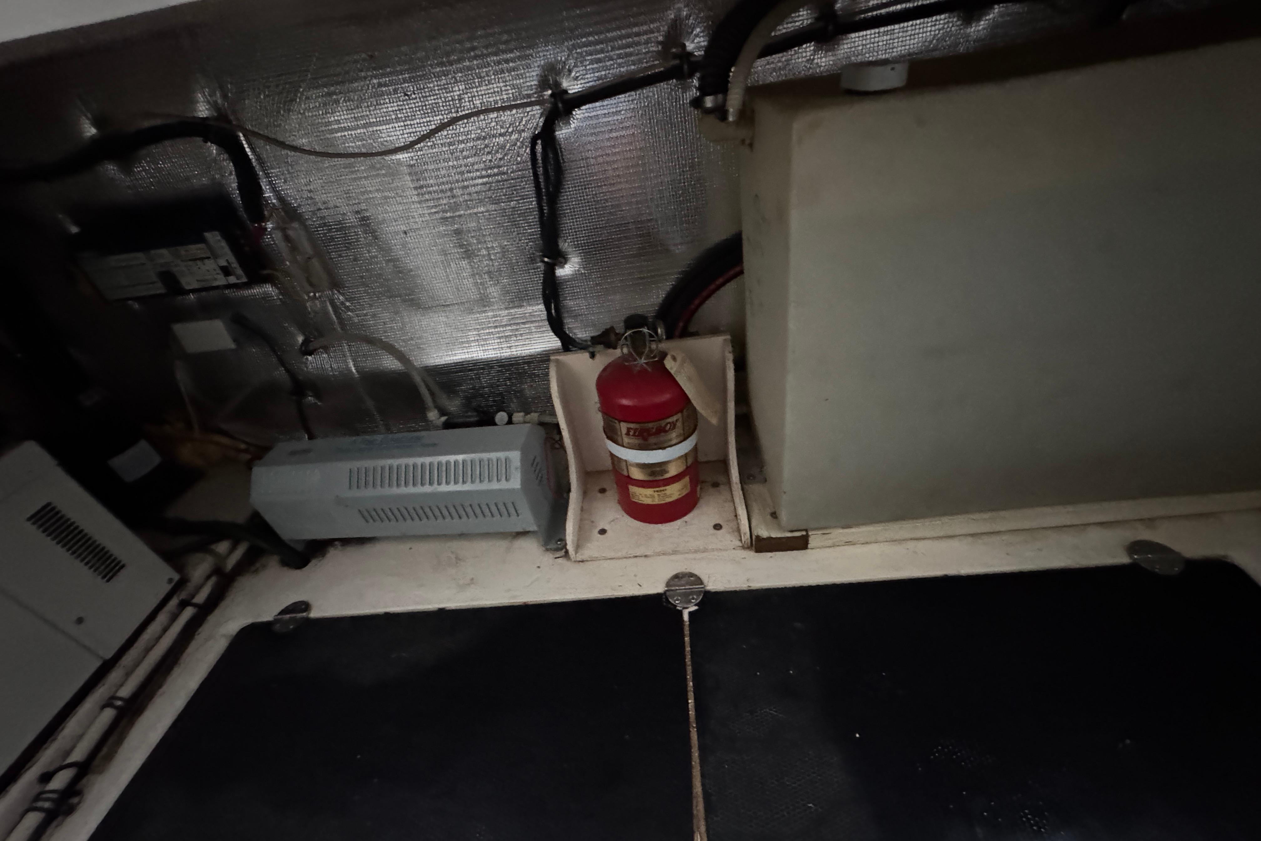 Engine room of 2006 Chaparral 330 Signature with fire extinguisher and equipment.