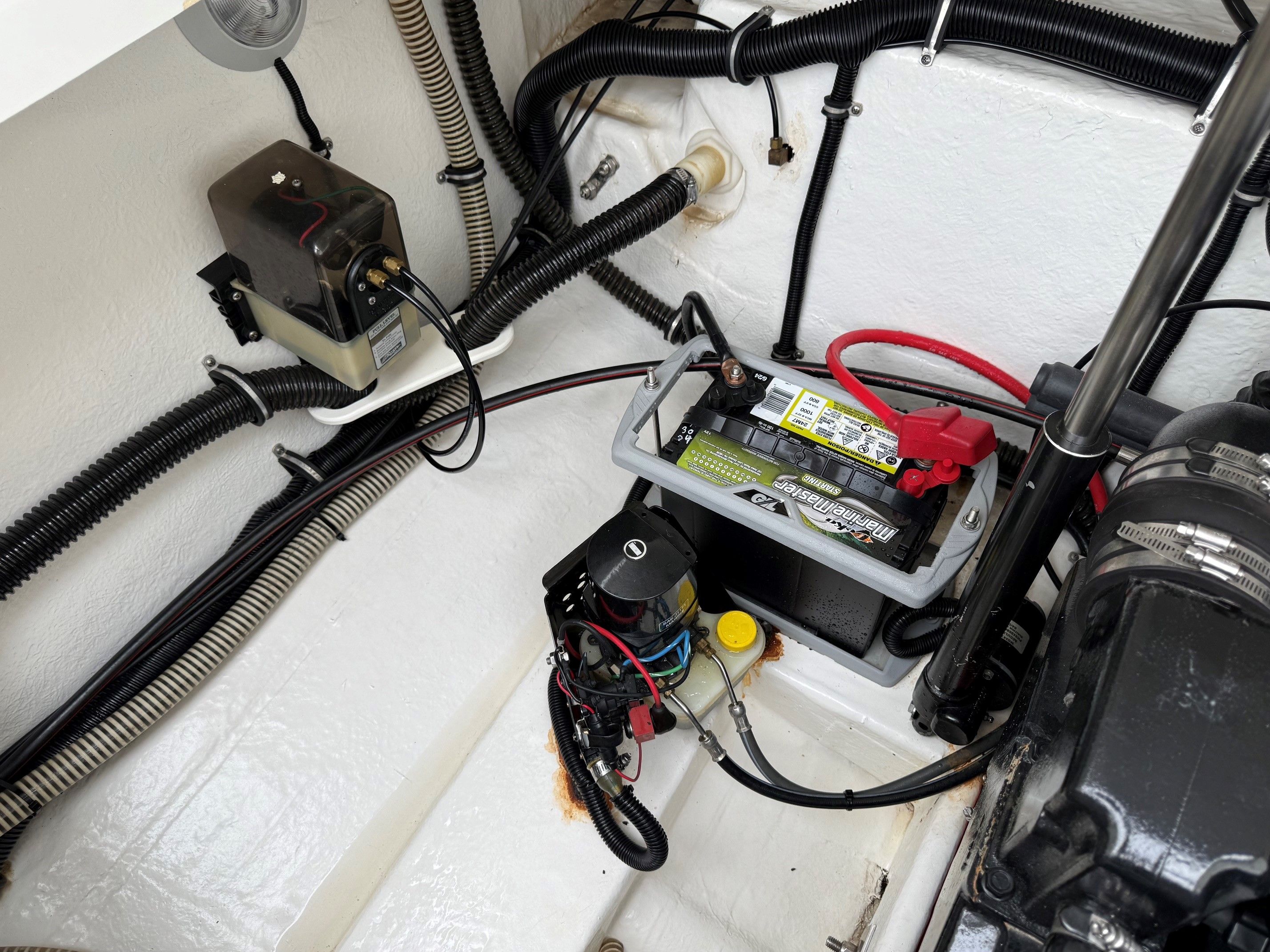Engine compartment of a 1998 Formula Thunderbird boat with battery.