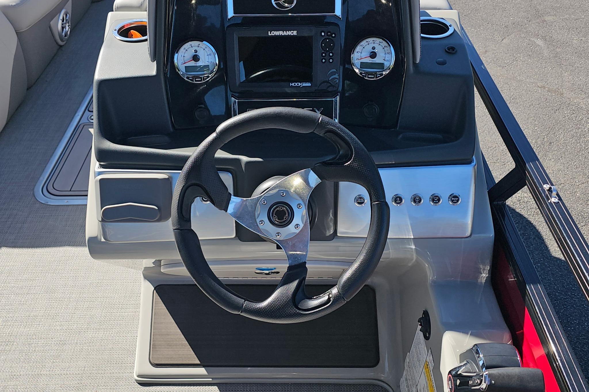 2023 Regency 250 DL3 boat dashboard with steering wheel and control panel.