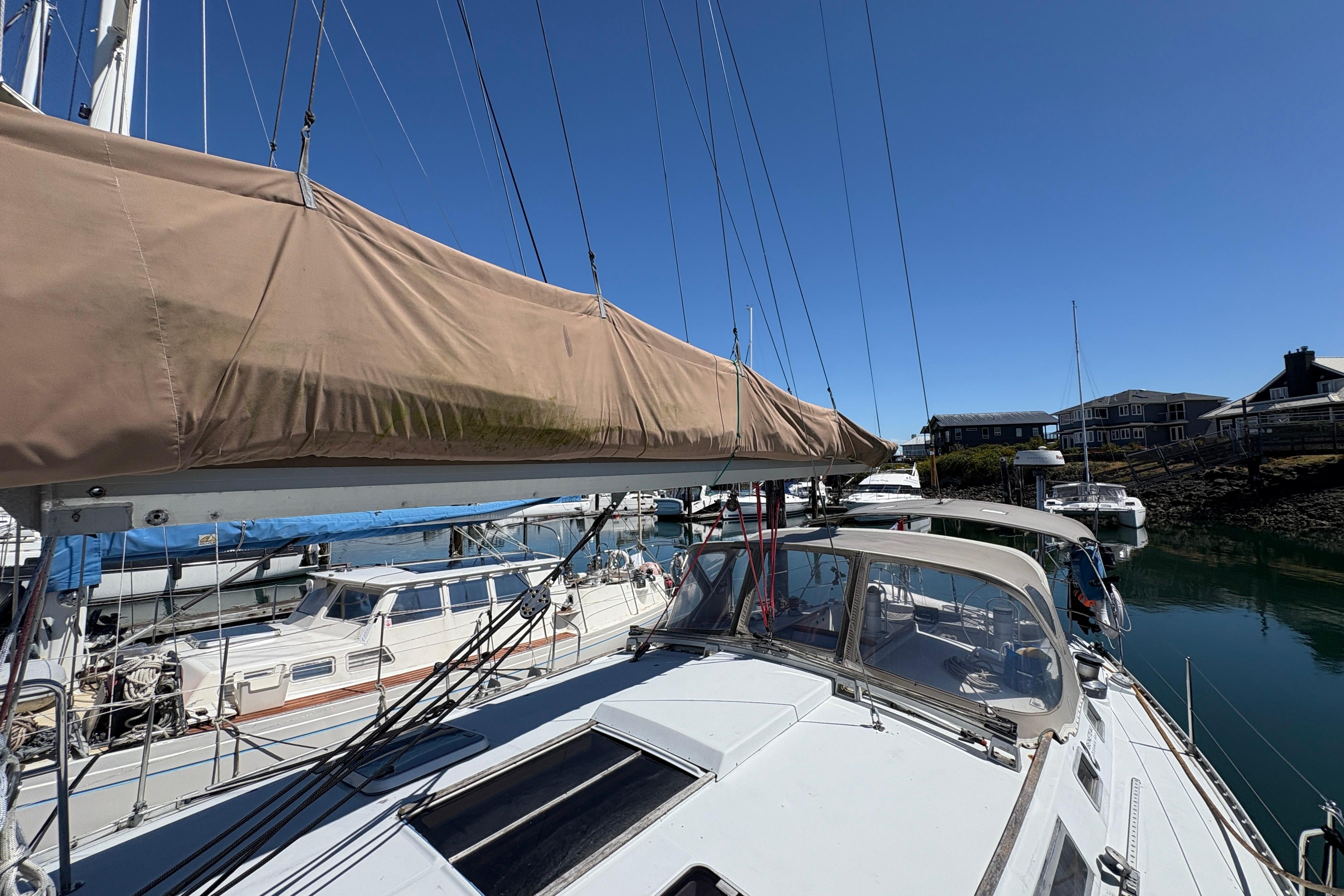 Sailboat Beneteau Oceanis 500, 1990 model, docked in a sunny marina.