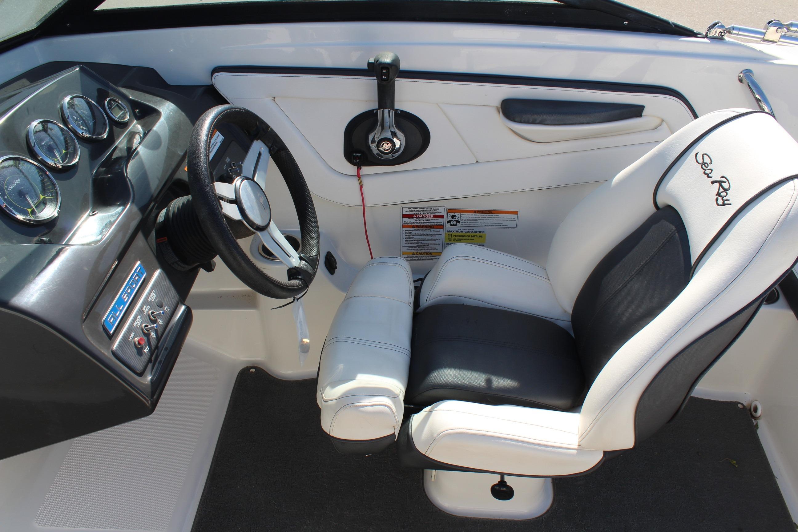 Interior of 2015 Sea Ray 19 SPX OB boat, featuring steering wheel and captain's seat.