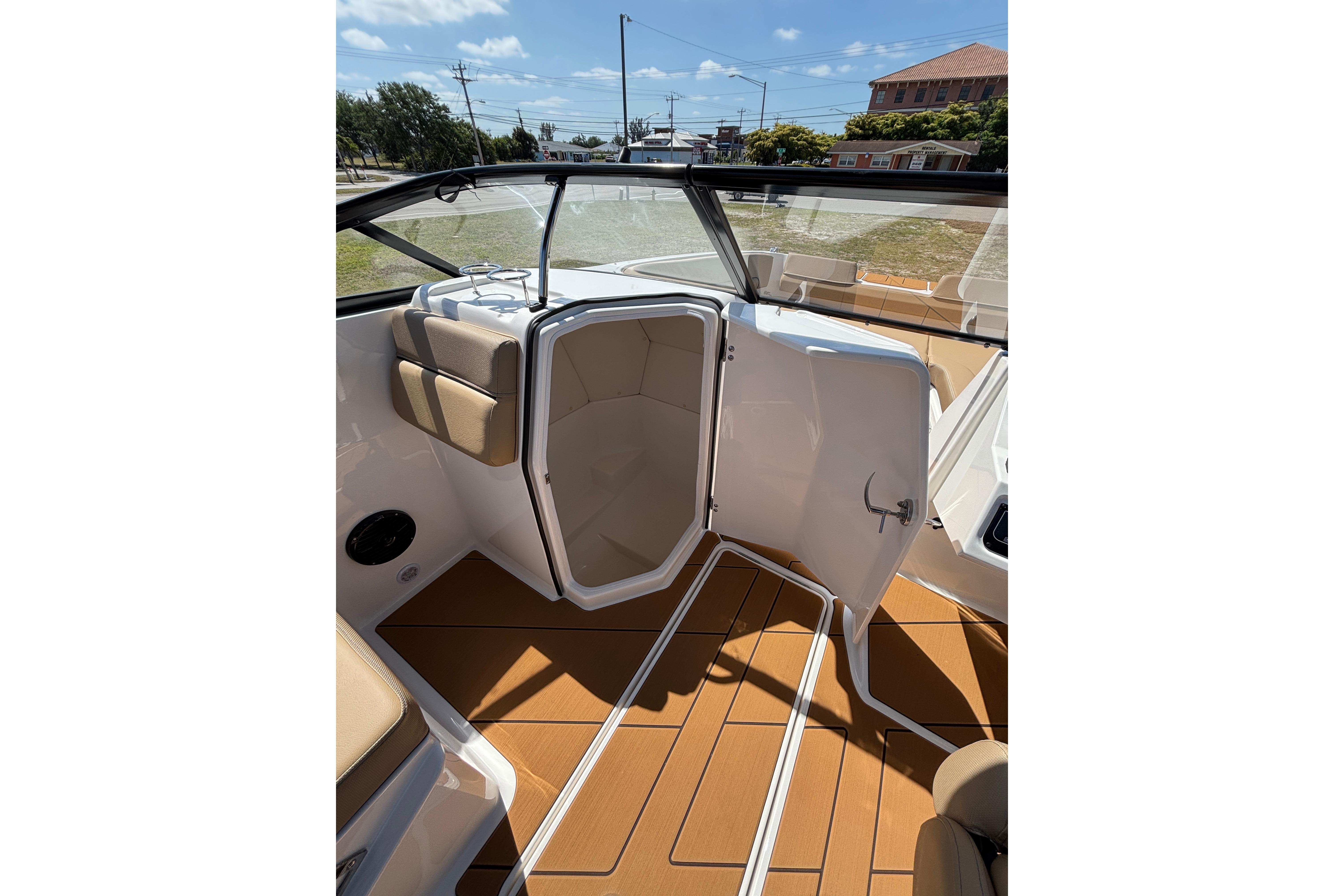 Interior view of 2026 Bayliner D22 boat with open cabin door and seating.