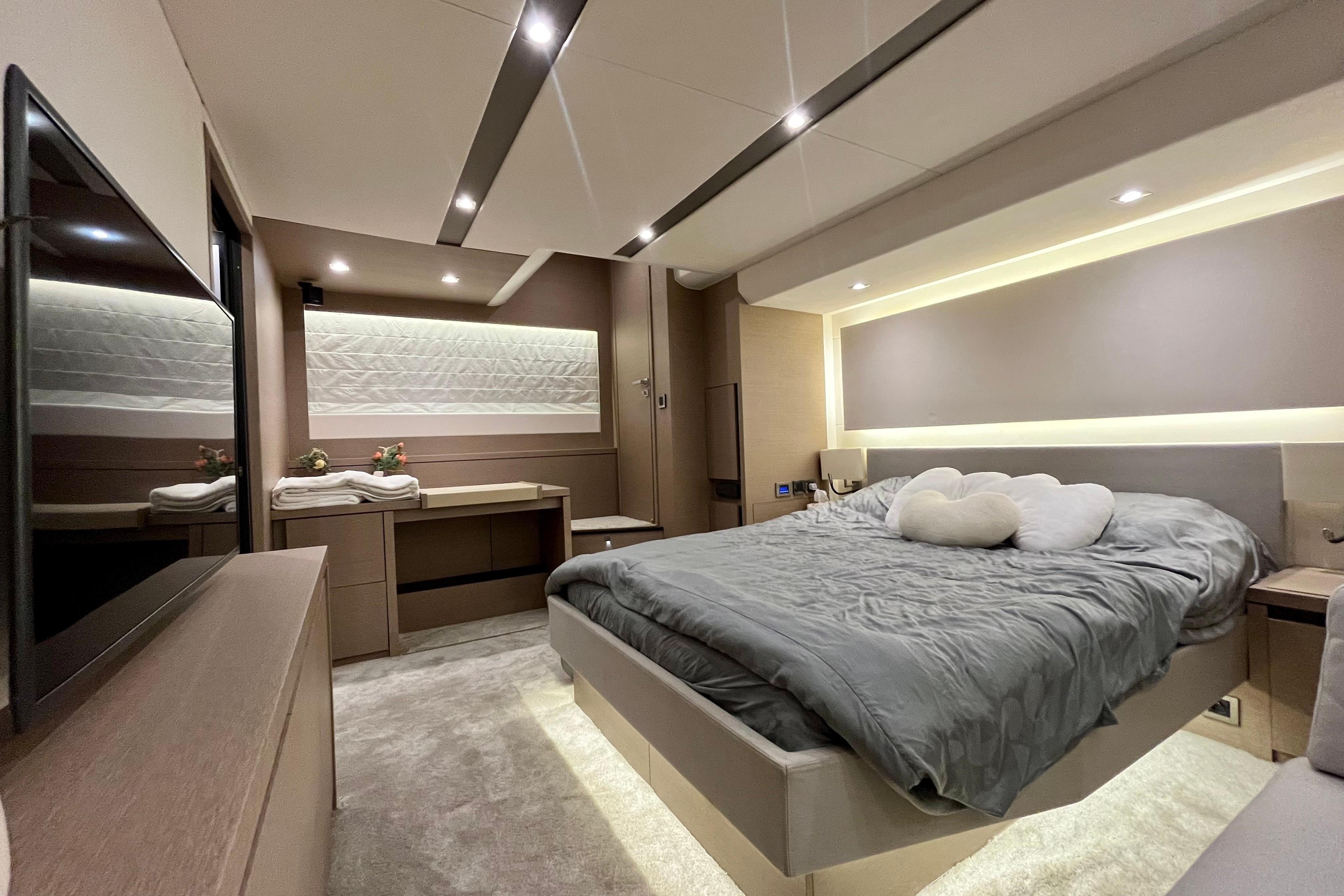 Luxurious 2019 Prestige 630 yacht bedroom with modern decor and ambient lighting.