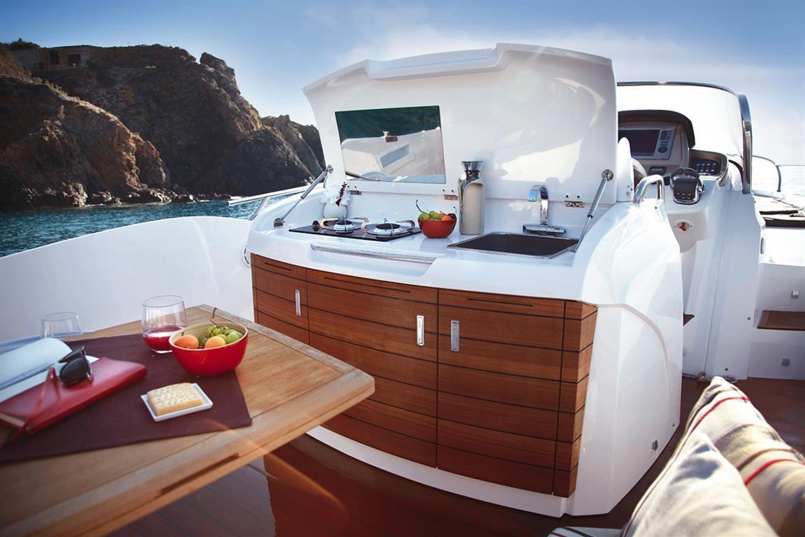 Luxurious 2013 Sessa Marine Key Largo 34 yacht with outdoor kitchen and scenic ocean view.