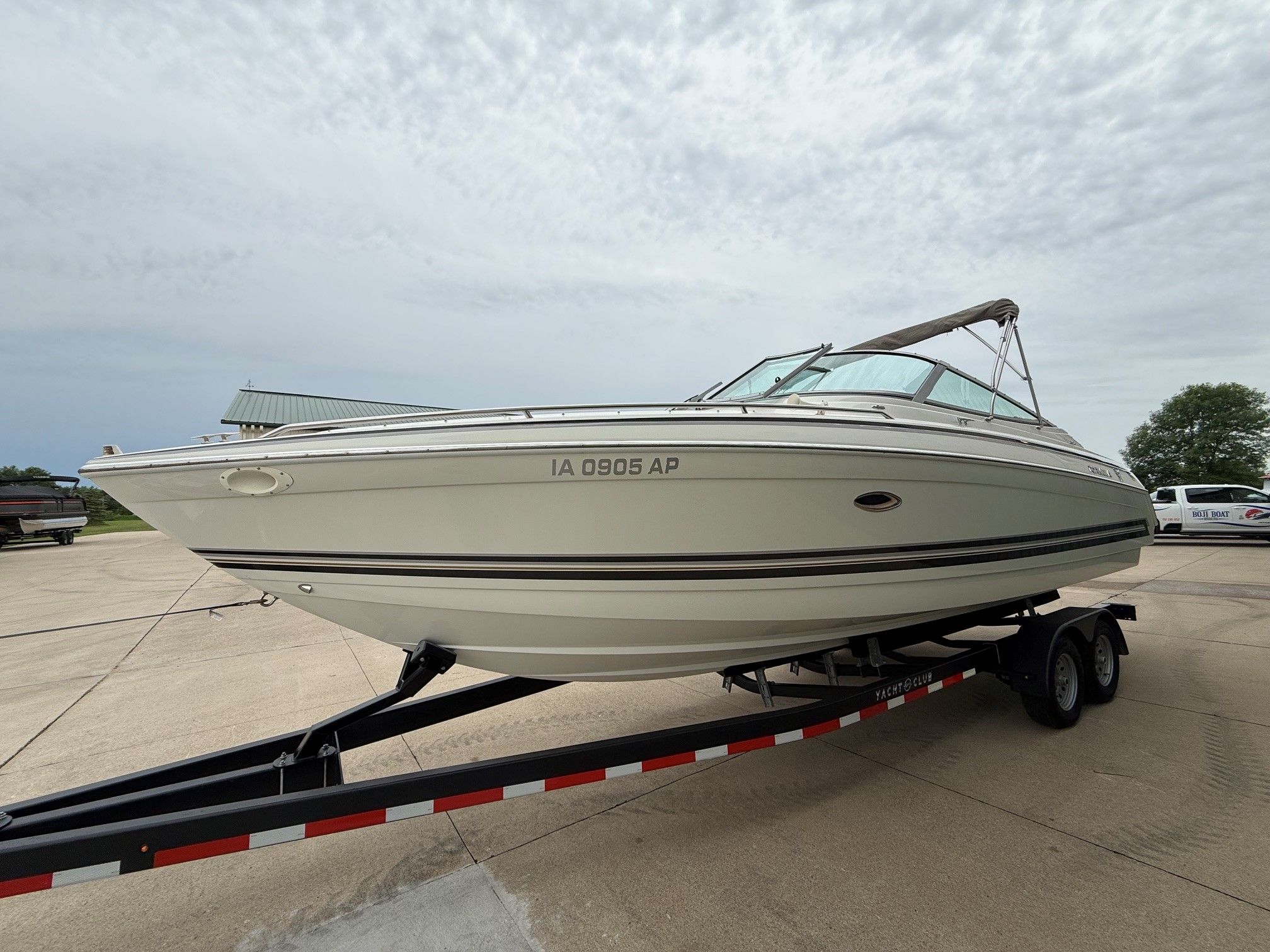 1998 Formula Thunderbird boat on trailer outdoors.