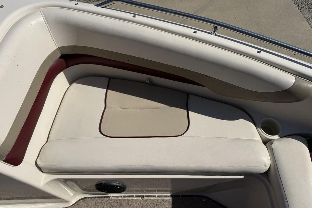 Interior seating of a 1999 Glastron GT 225 boat with beige upholstery.