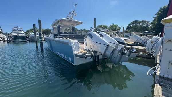 2025 Nimbus T11 boat docked in a marina under clear blue skies.