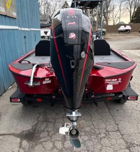 2025 Tracker Savage 215 boat, rear view, red and black design, parked outdoors.
