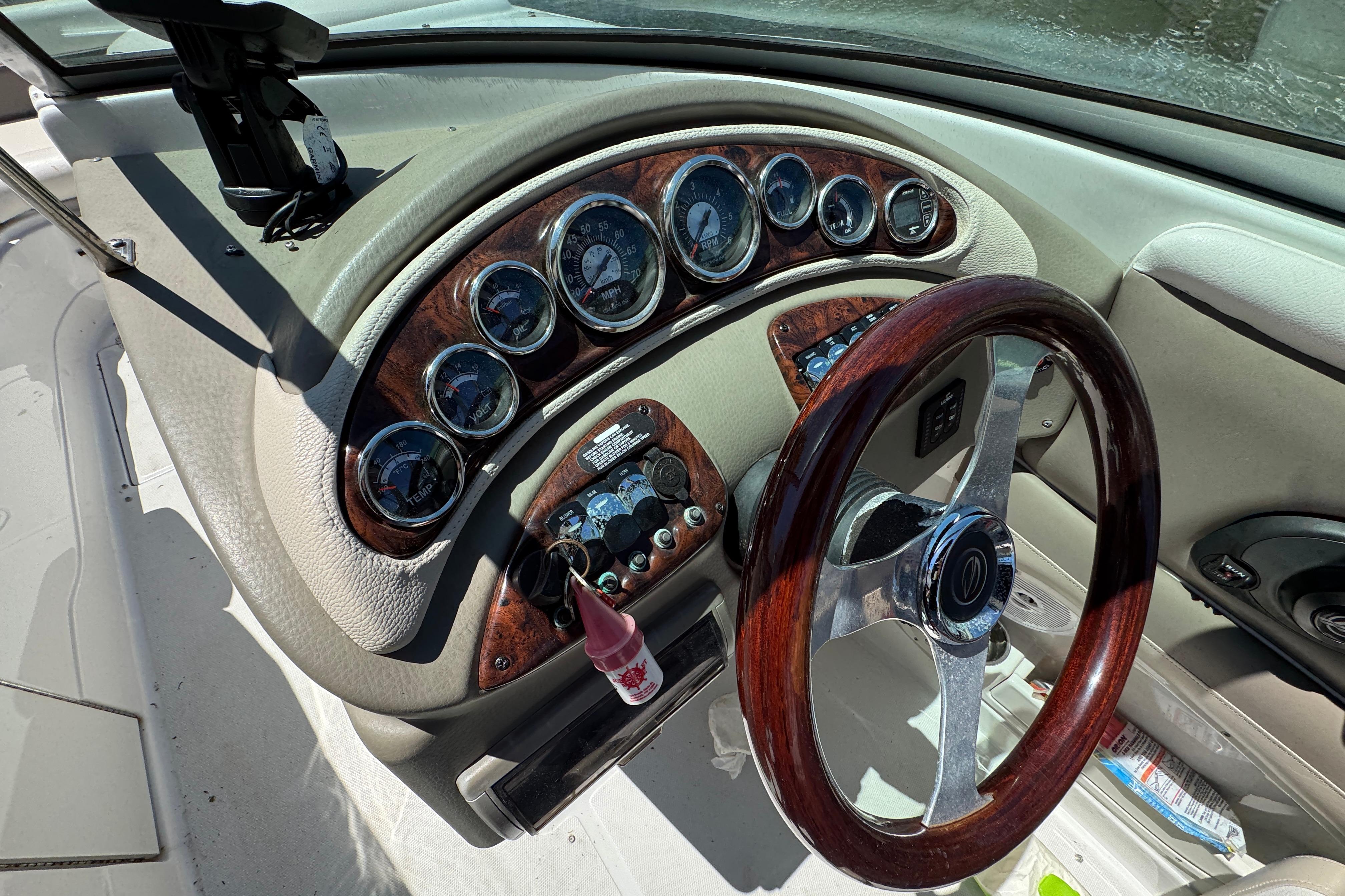 Dashboard of a 2013 Crownline Eclipse E6 XS boat with wood accents and gauges.
