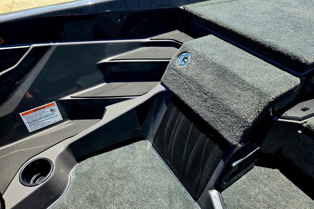 Interior view of 2026 Skeeter ZXE20 boat, featuring carpeted surfaces and storage compartments.