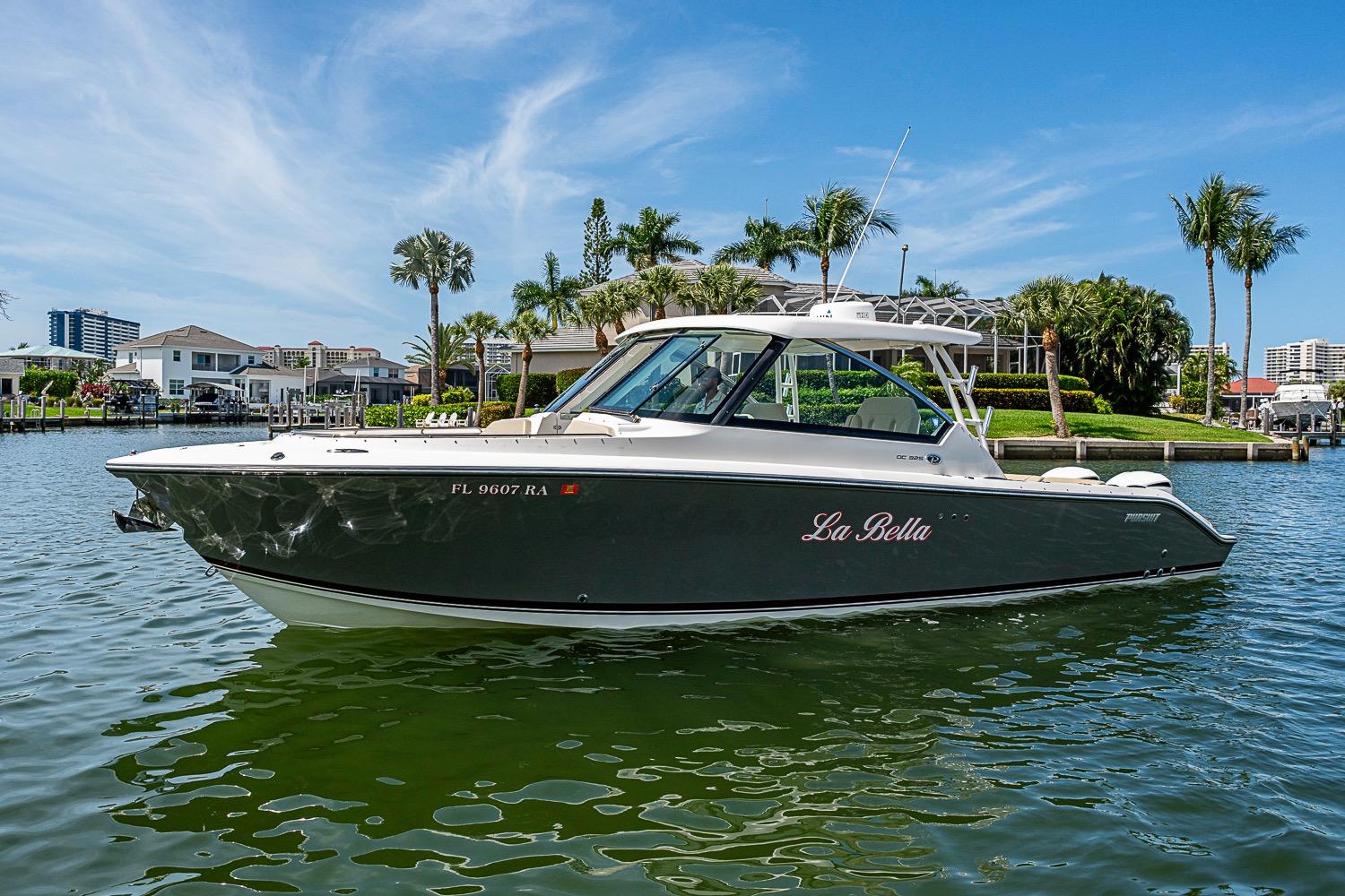 2016 Pursuit DC 325 Dual Console boat named "La Bella" on a scenic waterfront.