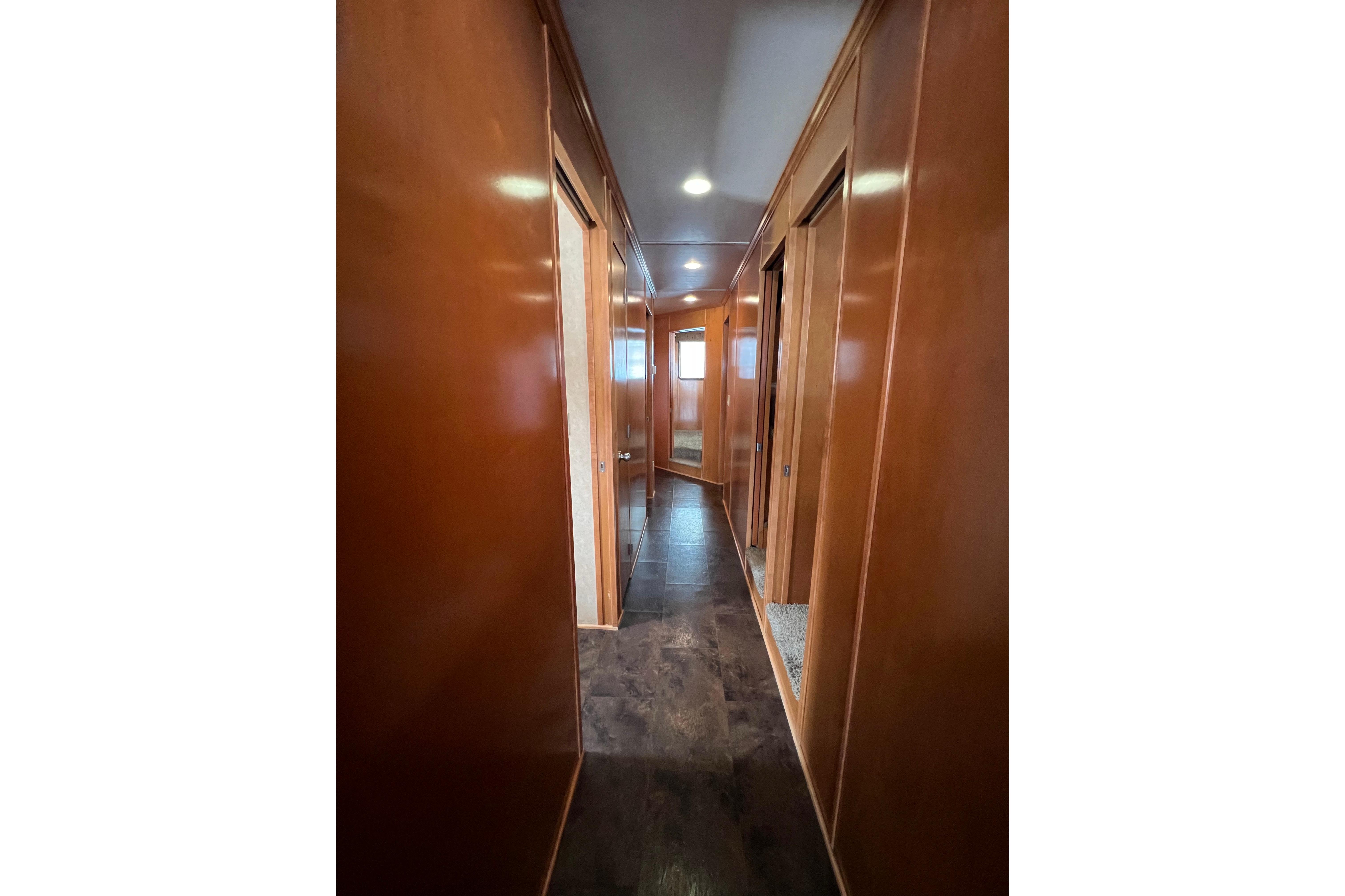 Interior hallway of 2013 Destination Yacht Lotta Yachta with wooden paneling and modern design.