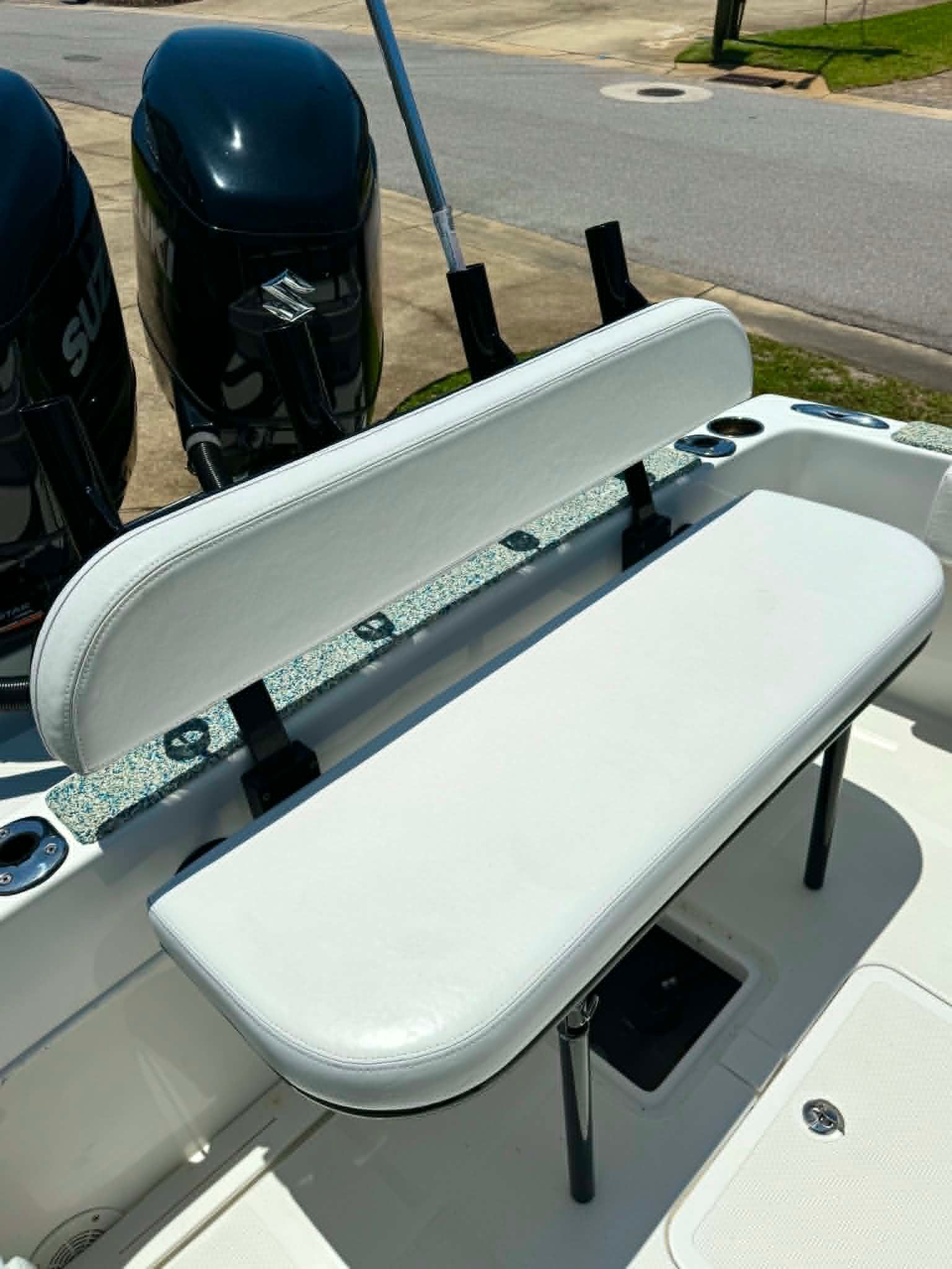 Dusky 278 XFT 2023 boat with white bench seat and engines.