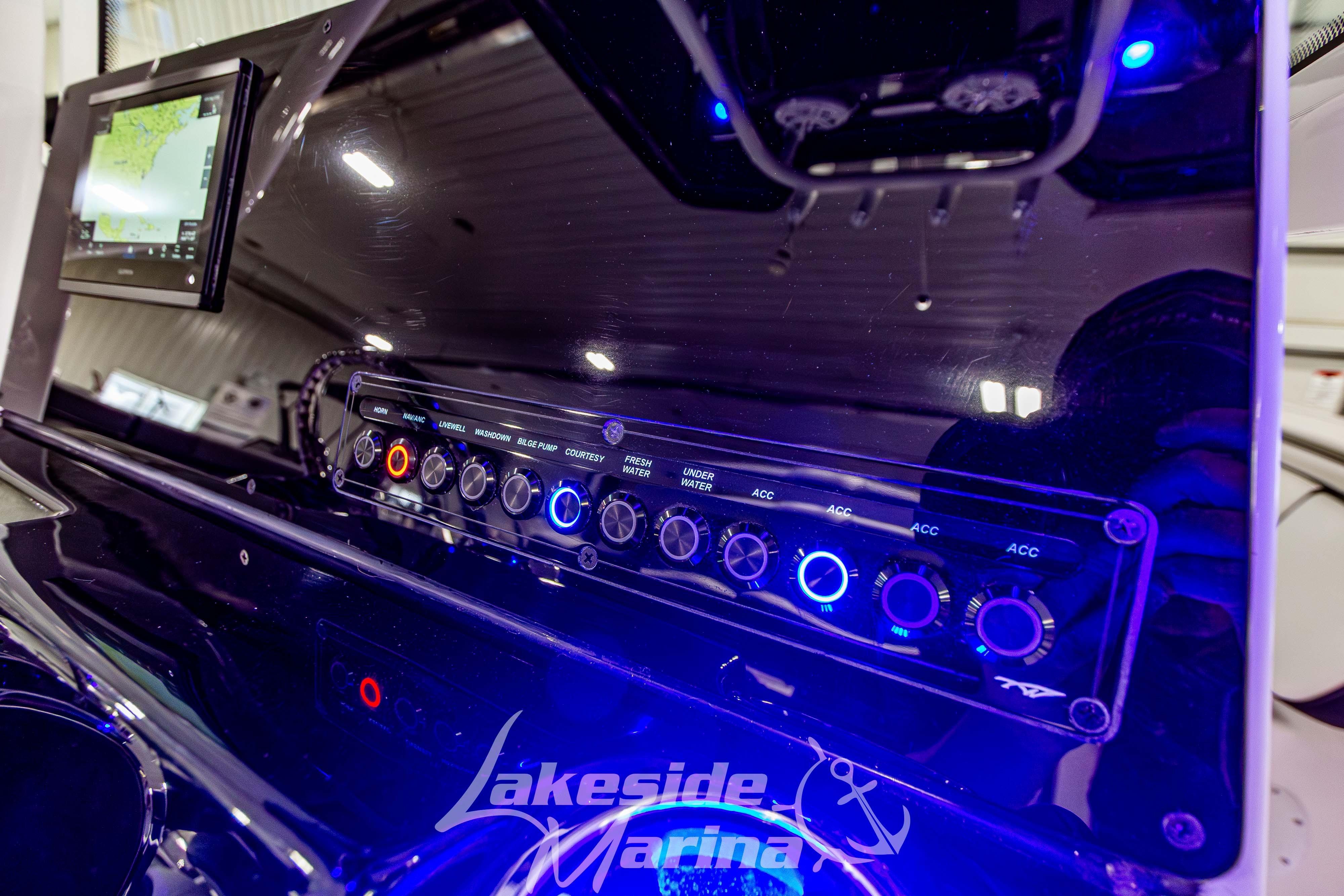 Control panel of 2026 Tidewater 198 CC Adventure boat with illuminated switches and display.