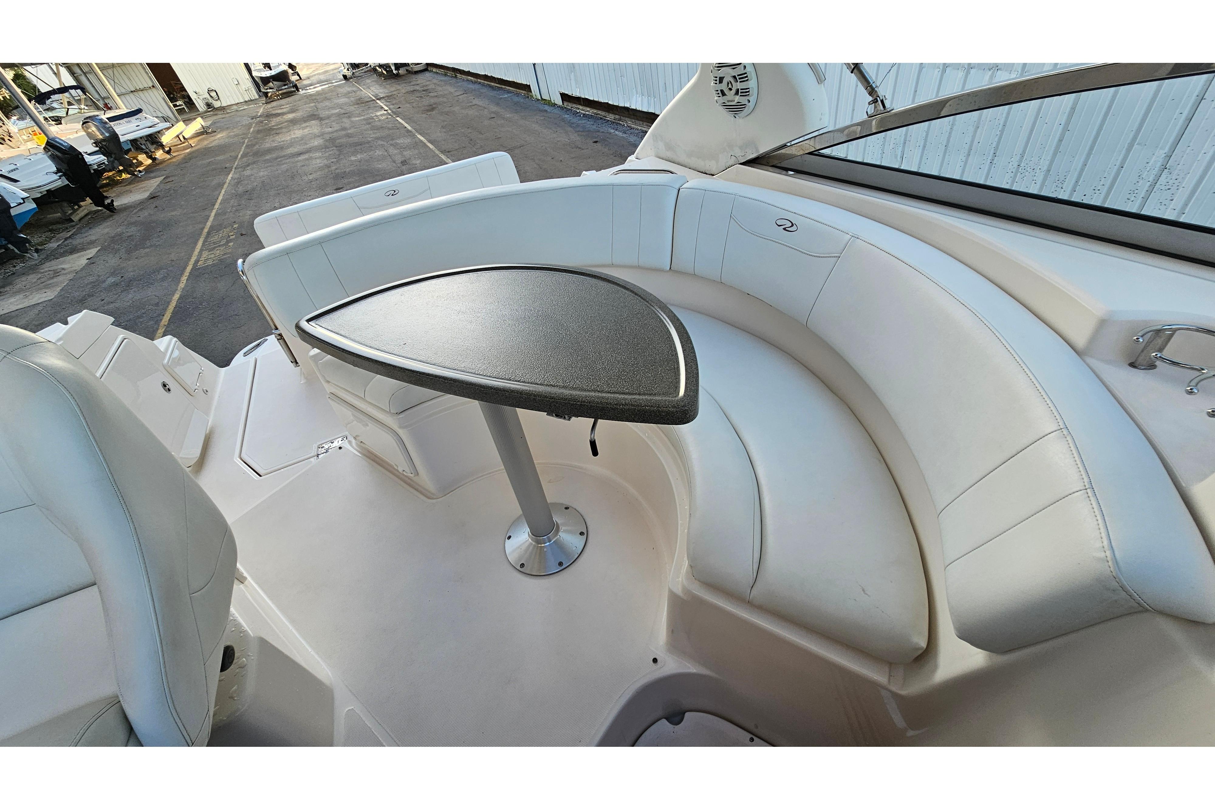 2005 Regal 3060 Window Express boat interior with curved seating and table.