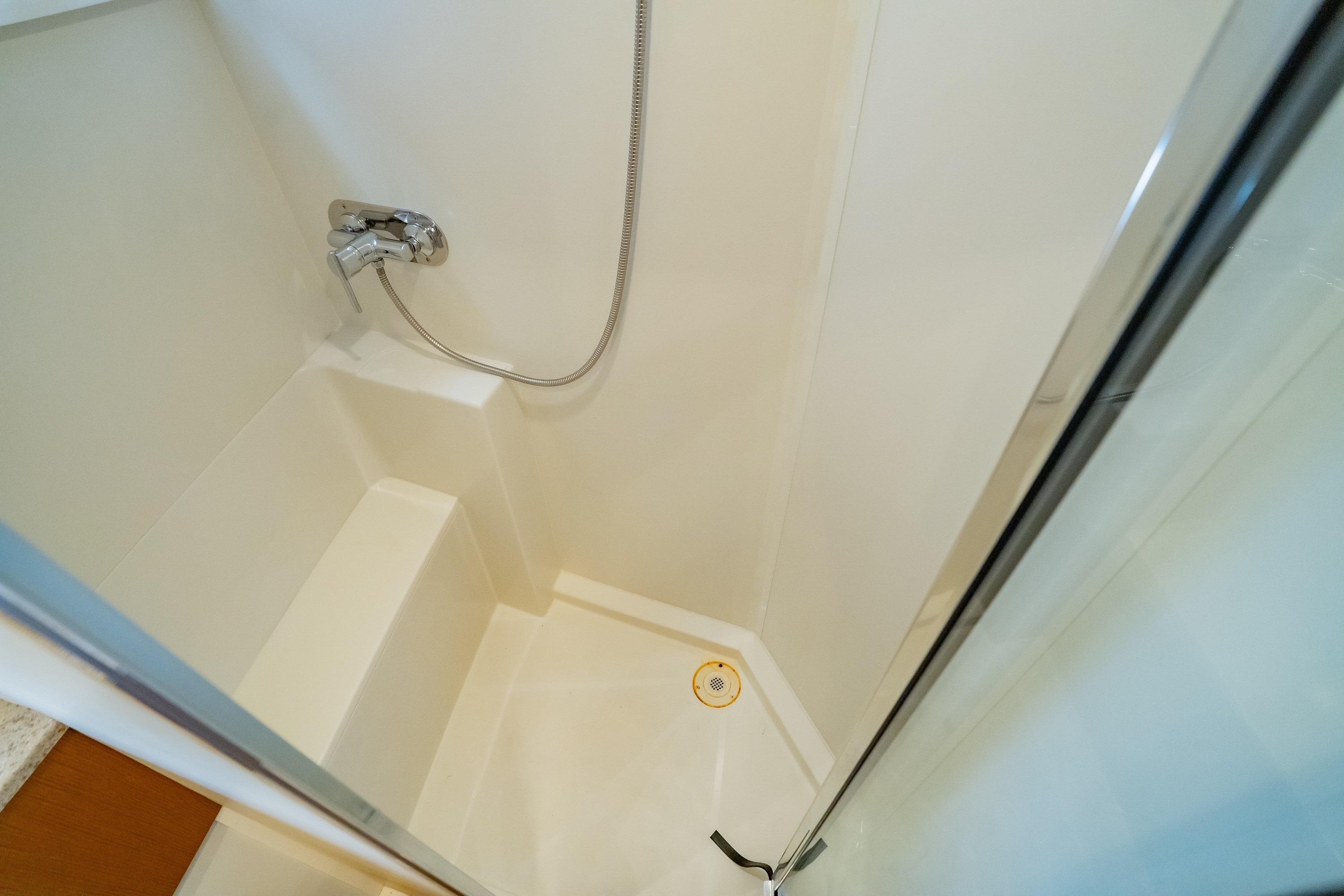 Shower area in 2011 Carver 44 Sojourn yacht, featuring a sleek design and chrome fixtures.