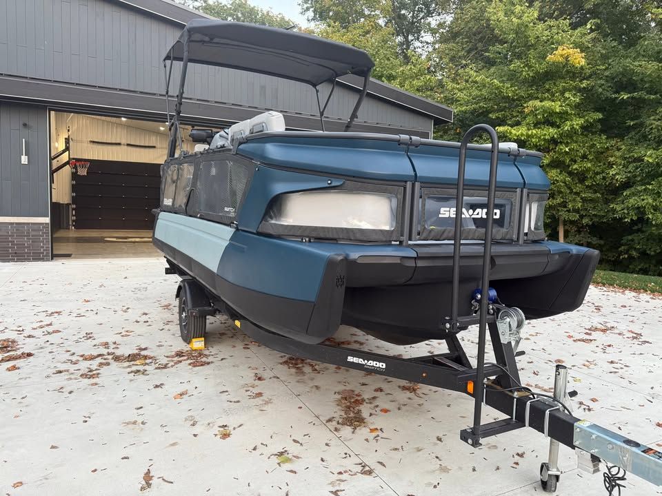 A 2025 Sea-Doo Switch Cruise Limited 21 on a trailer in front of a garage.