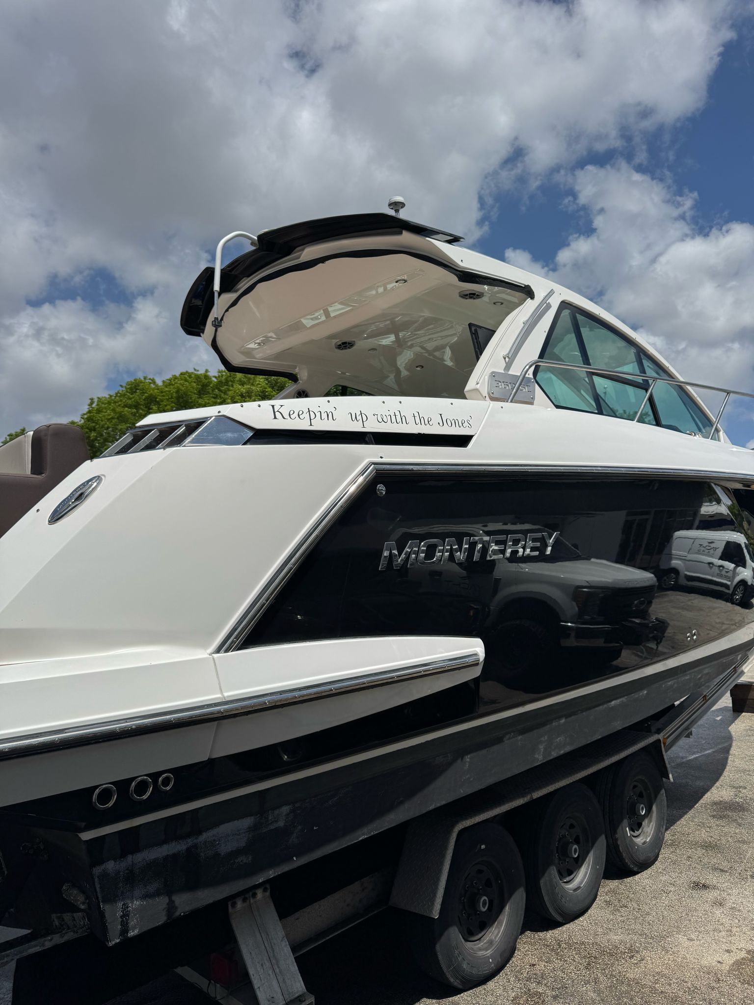 2015 Monterey 360 Sport Coupe boat on trailer, cloudy sky.