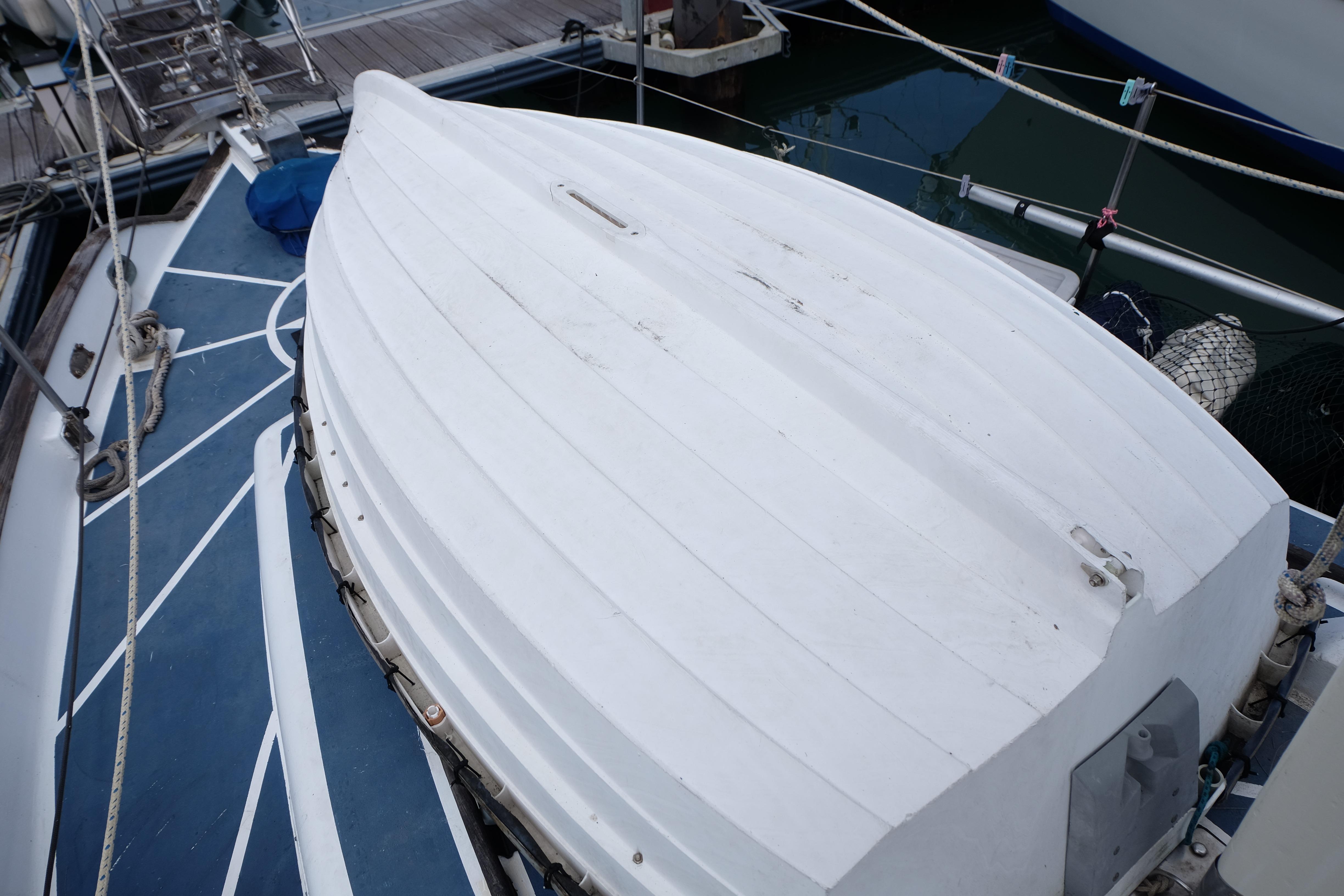 1979 Westwind 35 sailboat deck with white cover, docked at marina.