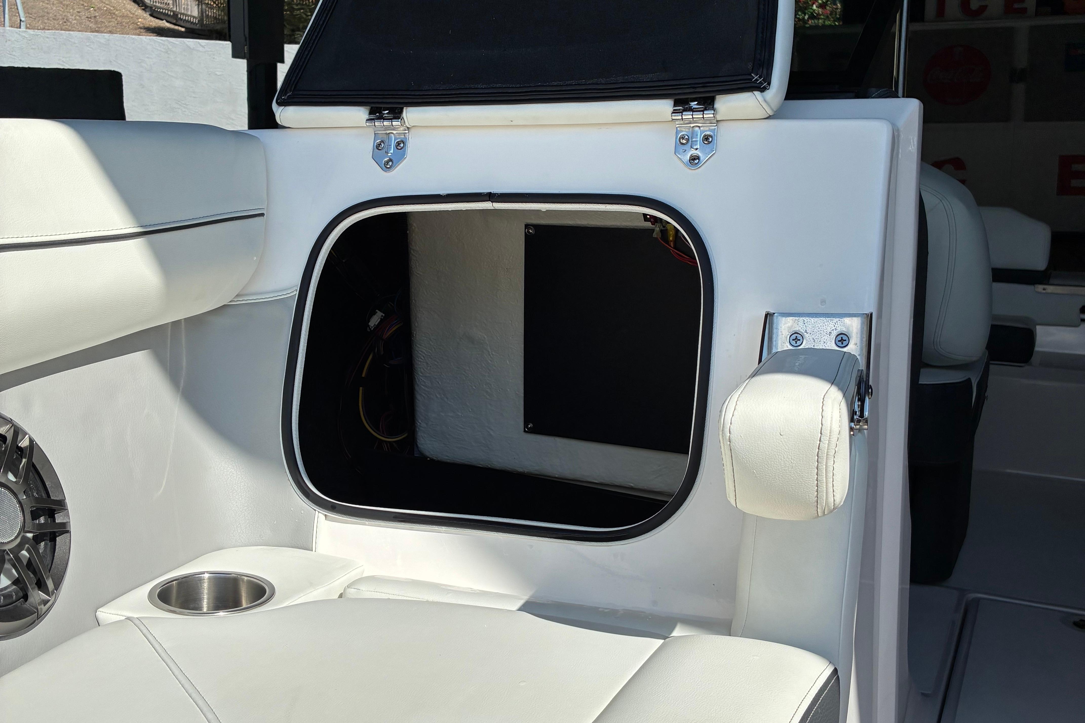 2025 Regal LS2 boat interior storage compartment with white seating and cup holder.