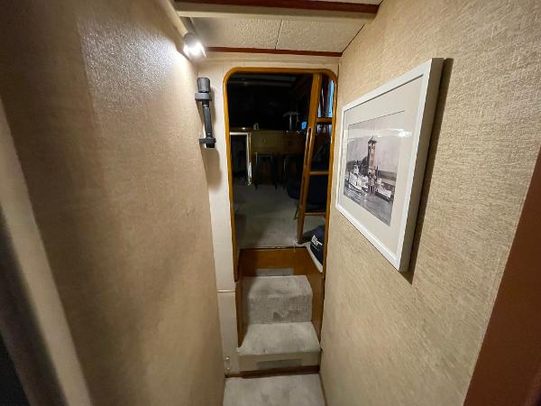 1951 Chris-Craft Catalina interior hallway with framed photo and soft lighting.