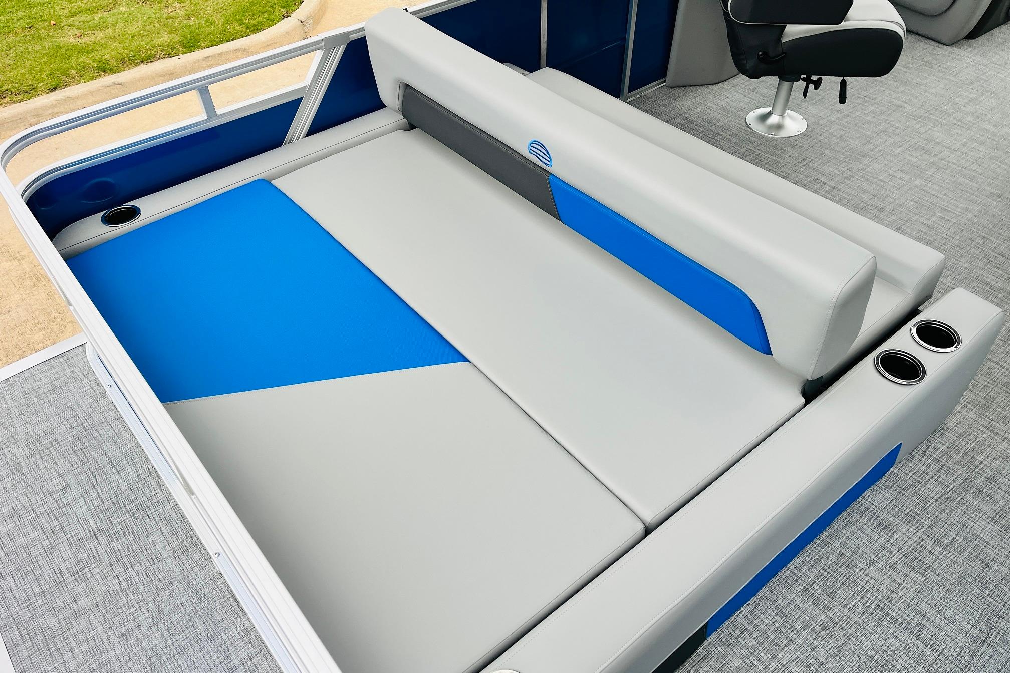 2026 Sun Tracker Party Barge 22 RF DLX interior with blue and gray seating.