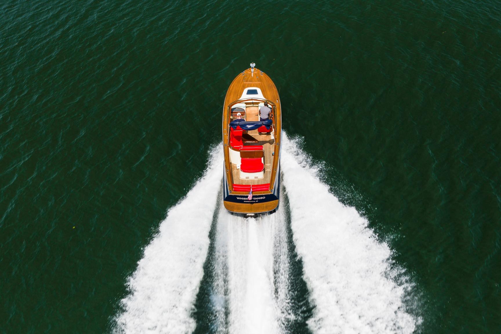 2005 Hinckley Talaria 29R cruising on open water, aerial view.