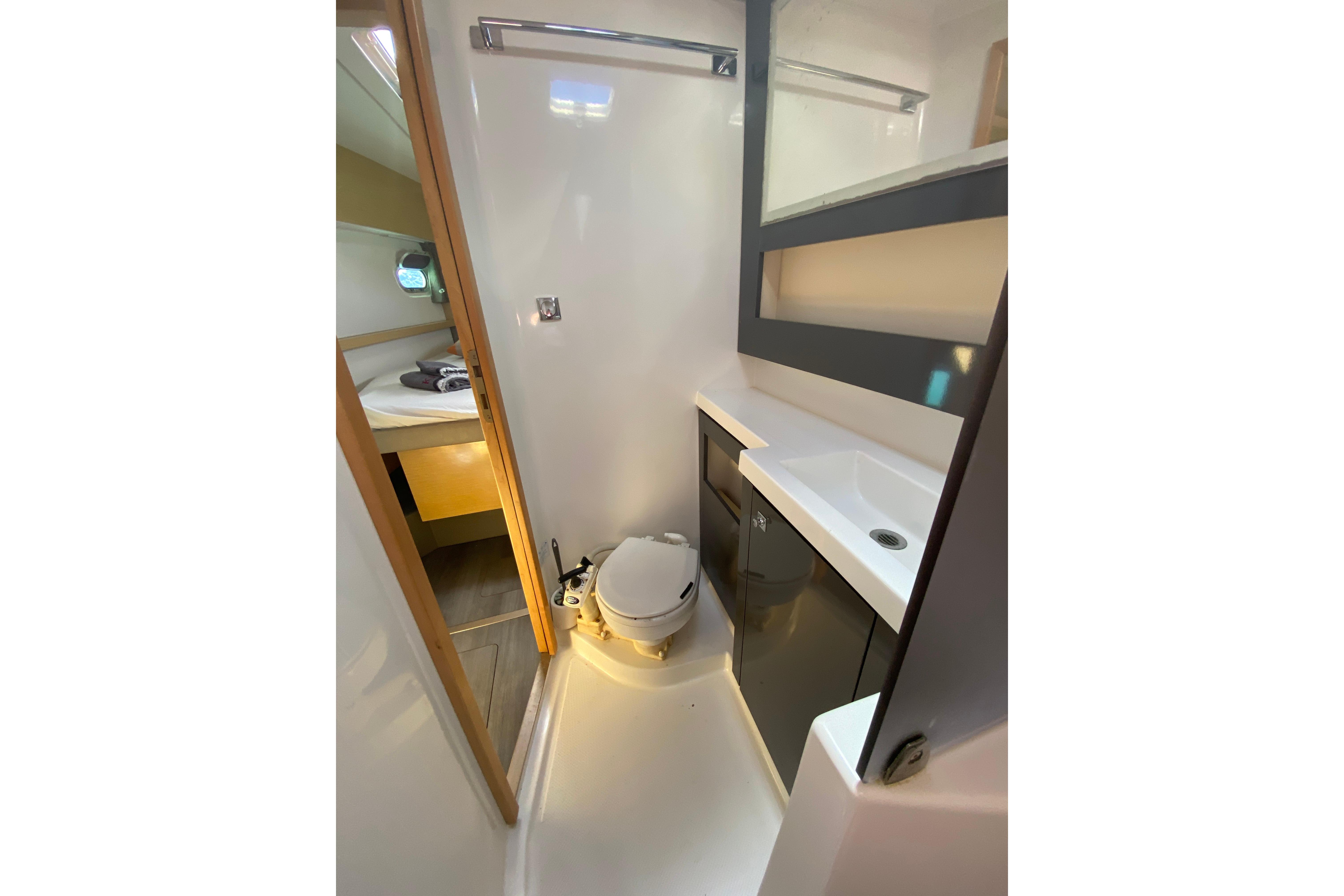 Bathroom interior of 2014 Fountaine Pajot Helia 44 catamaran, featuring modern fixtures and compact design.