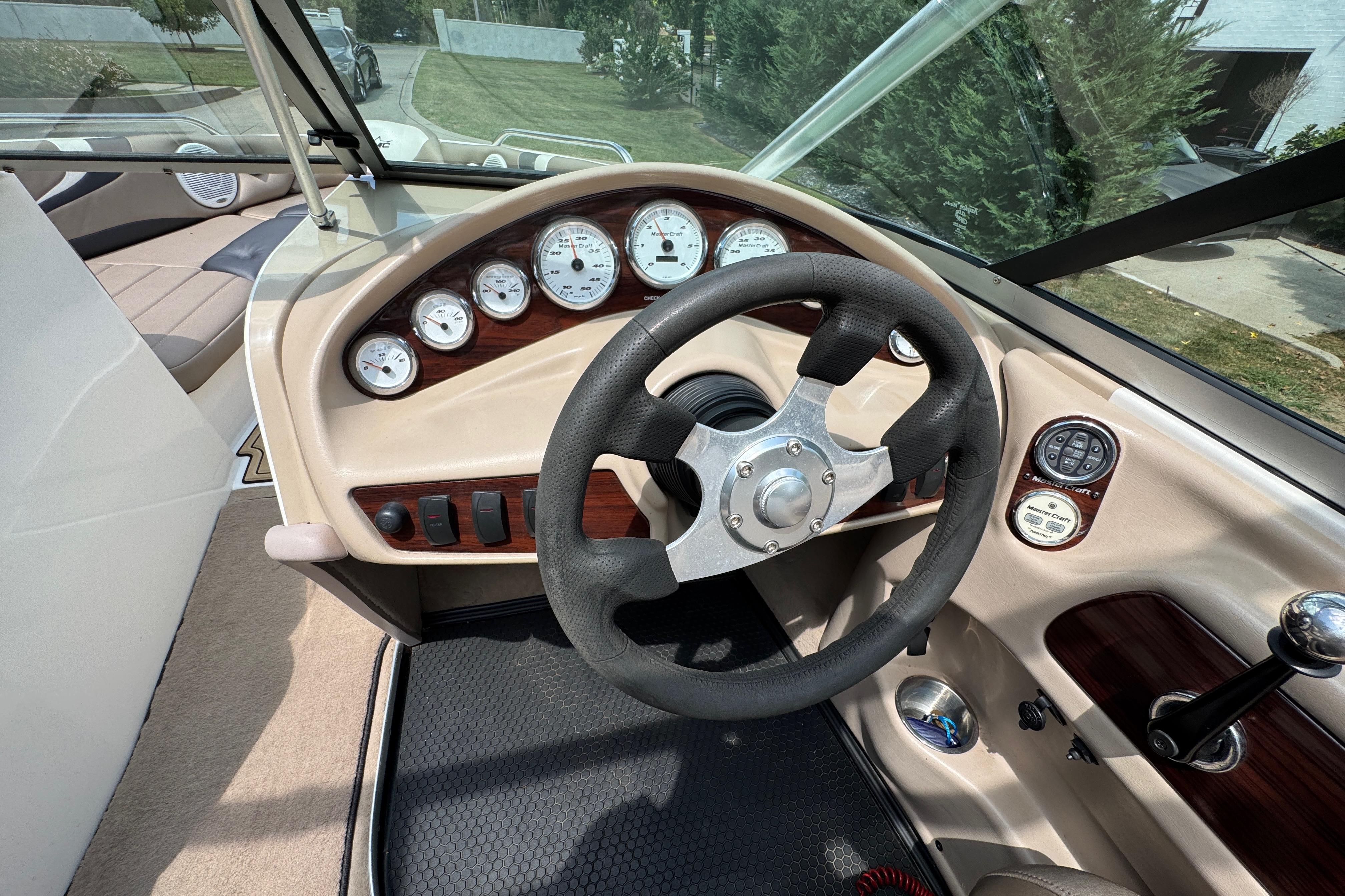 2002 MasterCraft ProStar 209 dashboard with steering wheel and gauges.