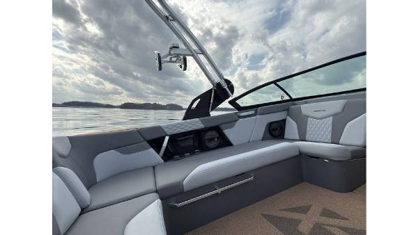 2023 MasterCraft XT22 boat interior with gray seating and lake view.