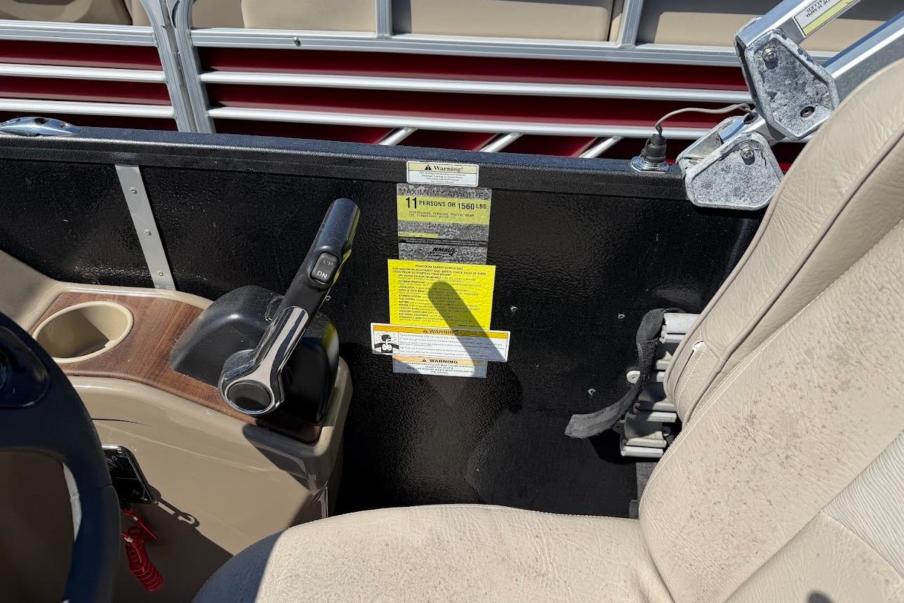 Interior of a 2013 Premier 221 Explorer boat showing control panel and seating.