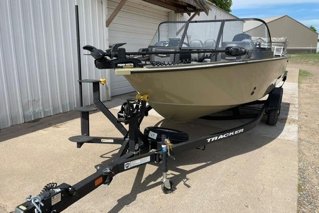2026 Tracker Targa V-18 WT boat on trailer, parked outdoors near a building.