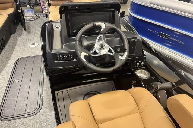 Interior view of 2026 Regency 230 DL boat with modern steering console and tan seating.