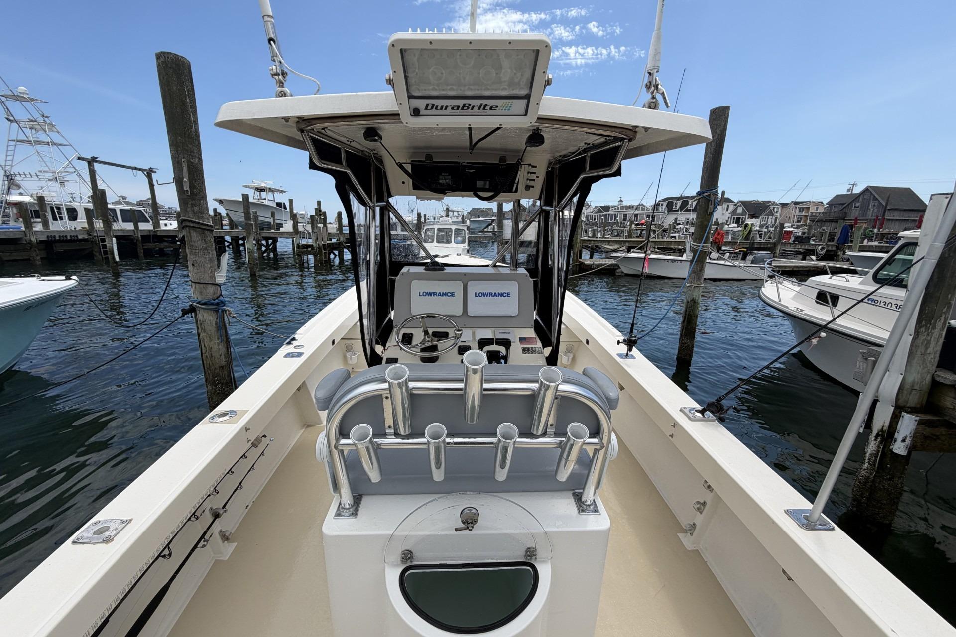 1999 Parker 2501 Center Console boat docked at marina, featuring Lowrance electronics.