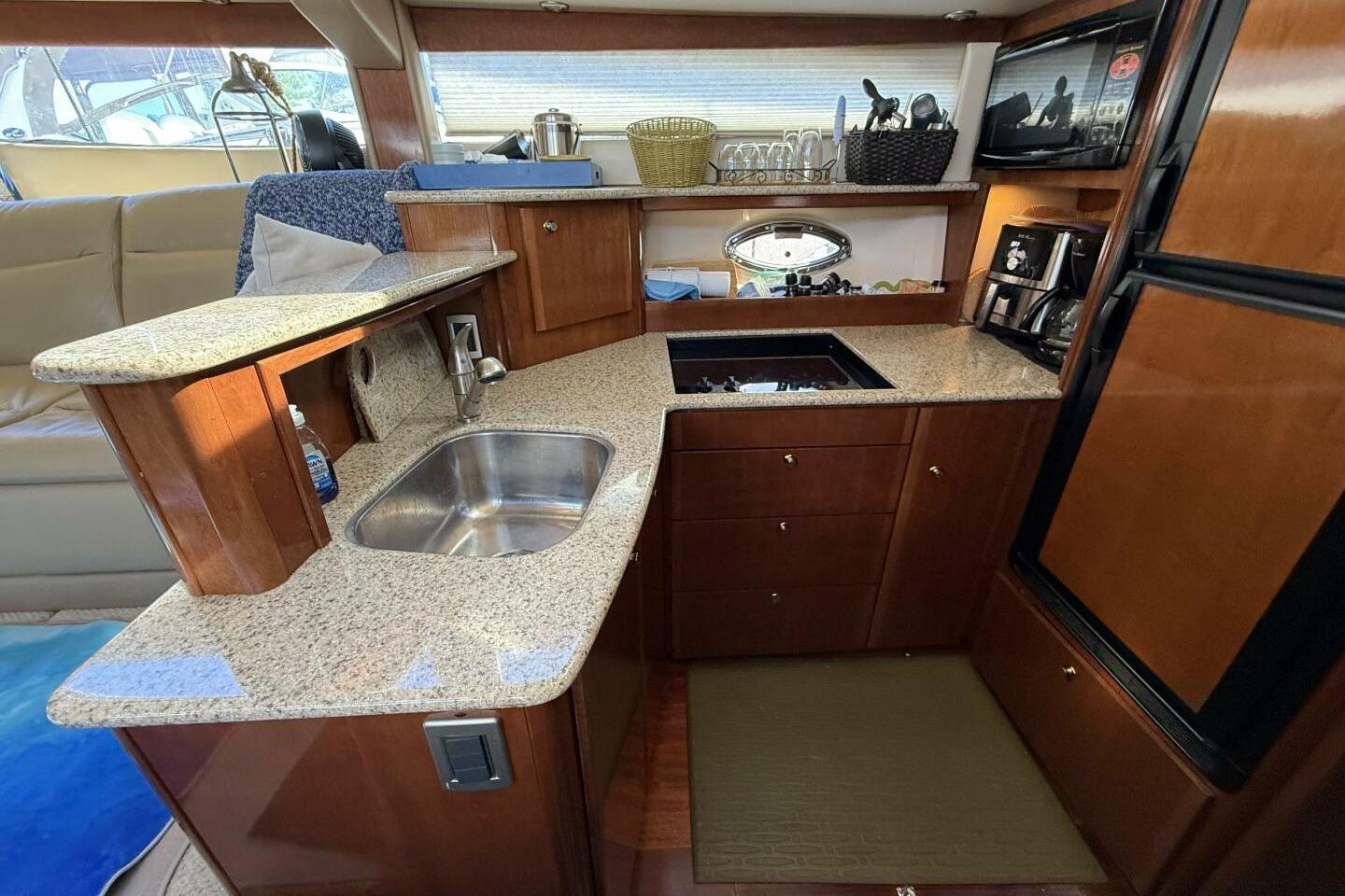 Luxurious kitchen interior of 2008 Meridian 459 Motoryacht with granite countertops and modern appliances.