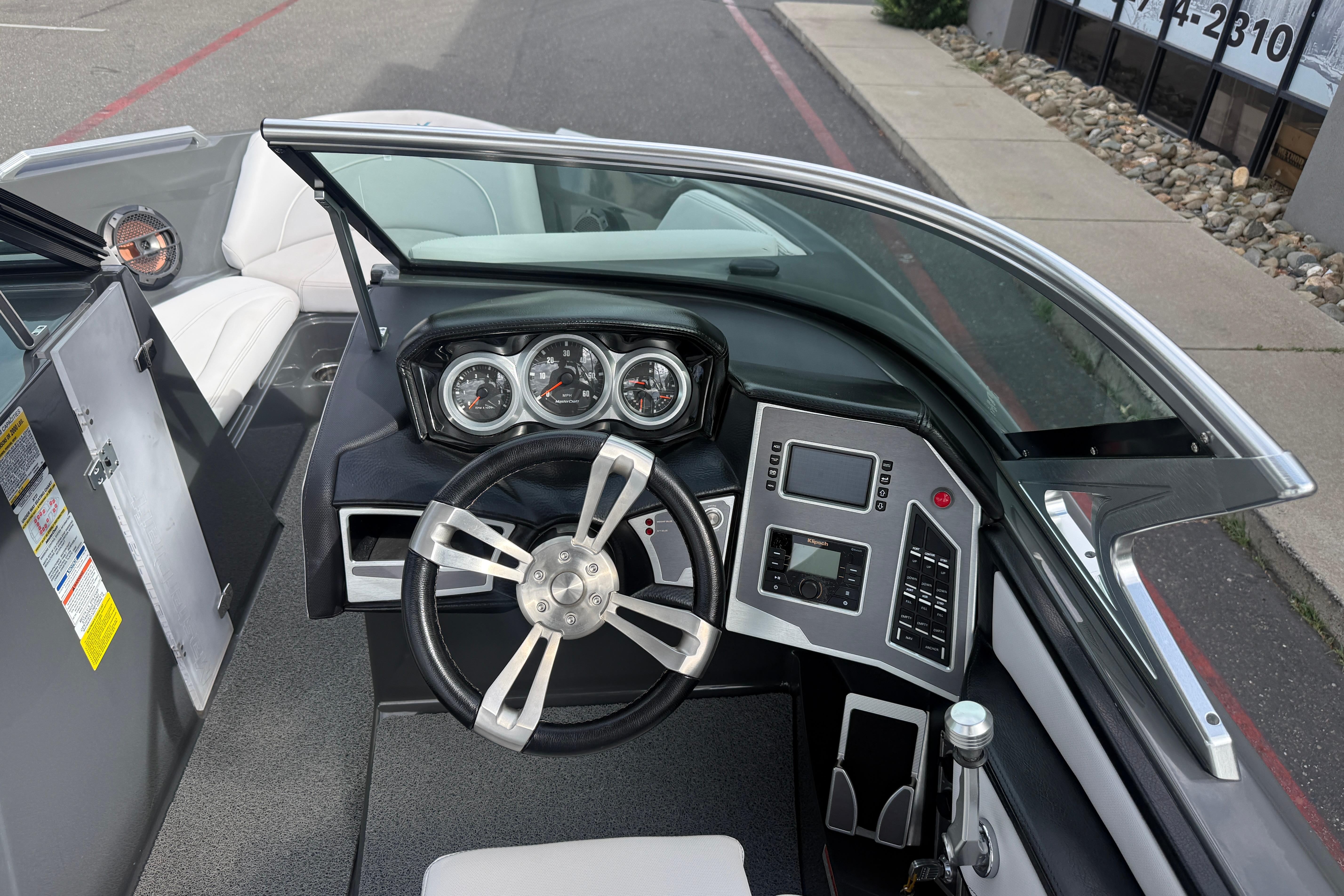 2018 MasterCraft XT21 boat dashboard with steering wheel and control panel.