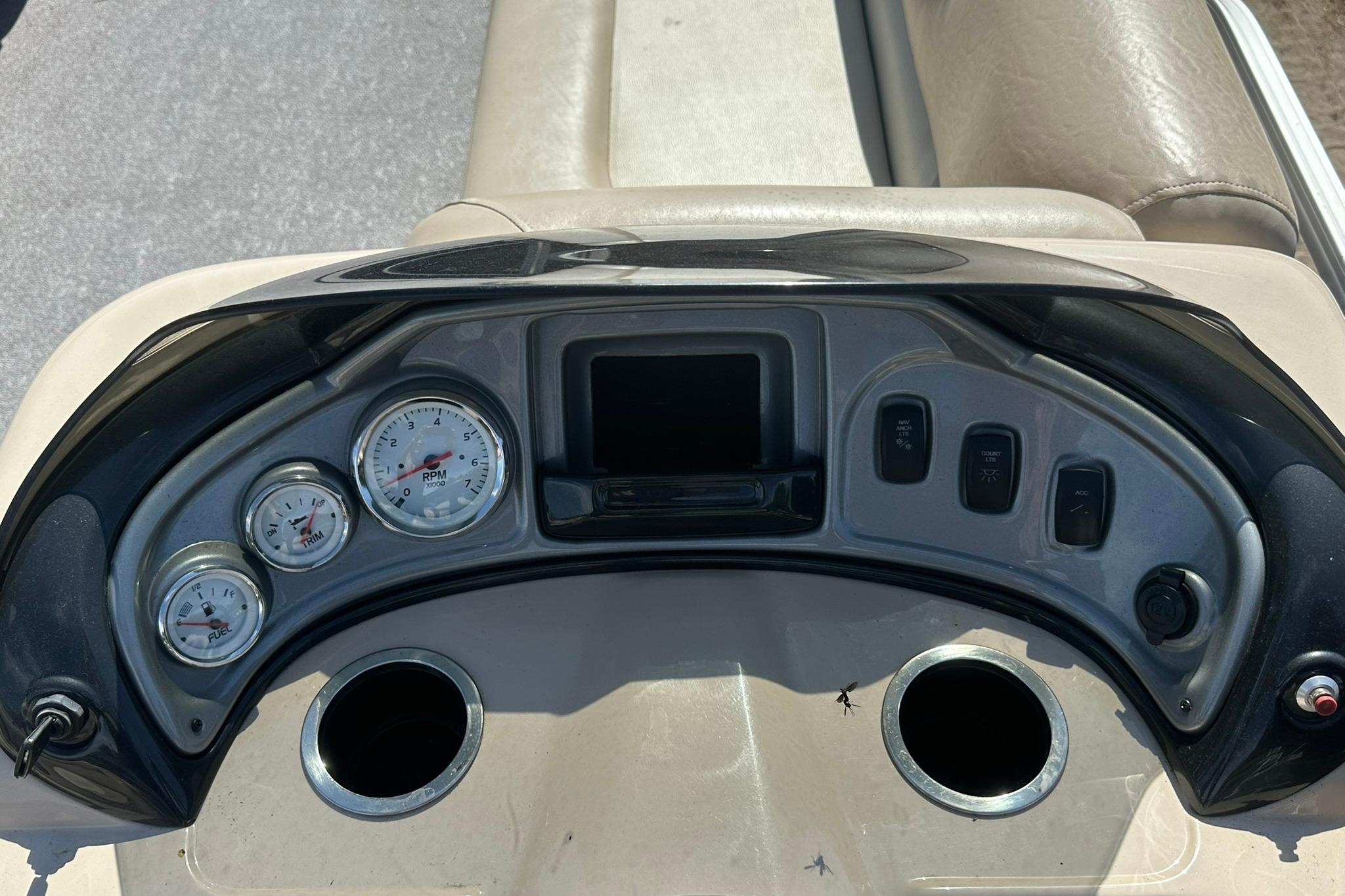 Dashboard of a 2016 SUNTRACKER Party Barge 20 pontoon boat with gauges and controls.